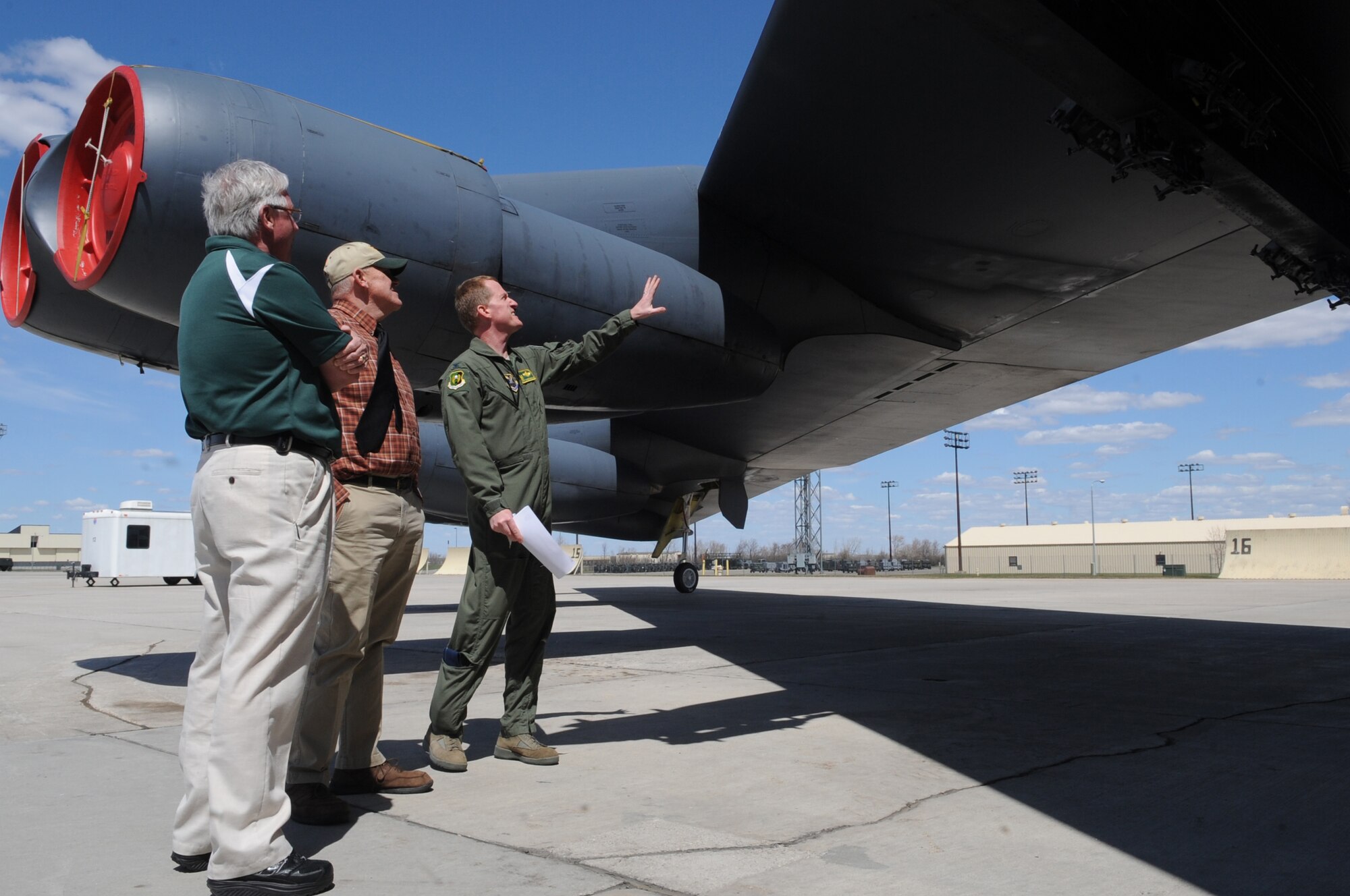 MINOT AIR FORCE BASE, N.D. –Col. Troy VanBemmelen(far right), 5th Operations Group commander, describes the B-52H Stratofortress’s capabilities to Bruce Carlson(center), Verendrye Electric general manager and  Military Affairs Committee  chairman, and Russ Gagnon, Dakota College programs director at Minot State University , during a B-52 static display tour here May 5. The tour portion of the monthly MAC meeting brings together local civic and base leadership to discuss topics affecting the base, Minot and the surrounding communities. This month’s meeting focused on B-52s and the 5th BW’s role in Air Force Global Strike Command’s Continuous Bomber Presence mission. (U.S. Air Force photo/Tech. Sgt. Thomas Dow)