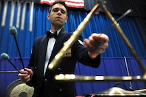 MINOT, N.D. -- Staff Sgt. Steve Helford, Heartland of America Air Force Band percussionist, plays the triangle during a concert at the Minot Municipal Auditorium May 4. The vibrant ensemble presents exciting, uplifting music with innovation and professionalism inspiring patriotism to global audiences. (U.S. Air Force Photo/Senior Airman Lopez)