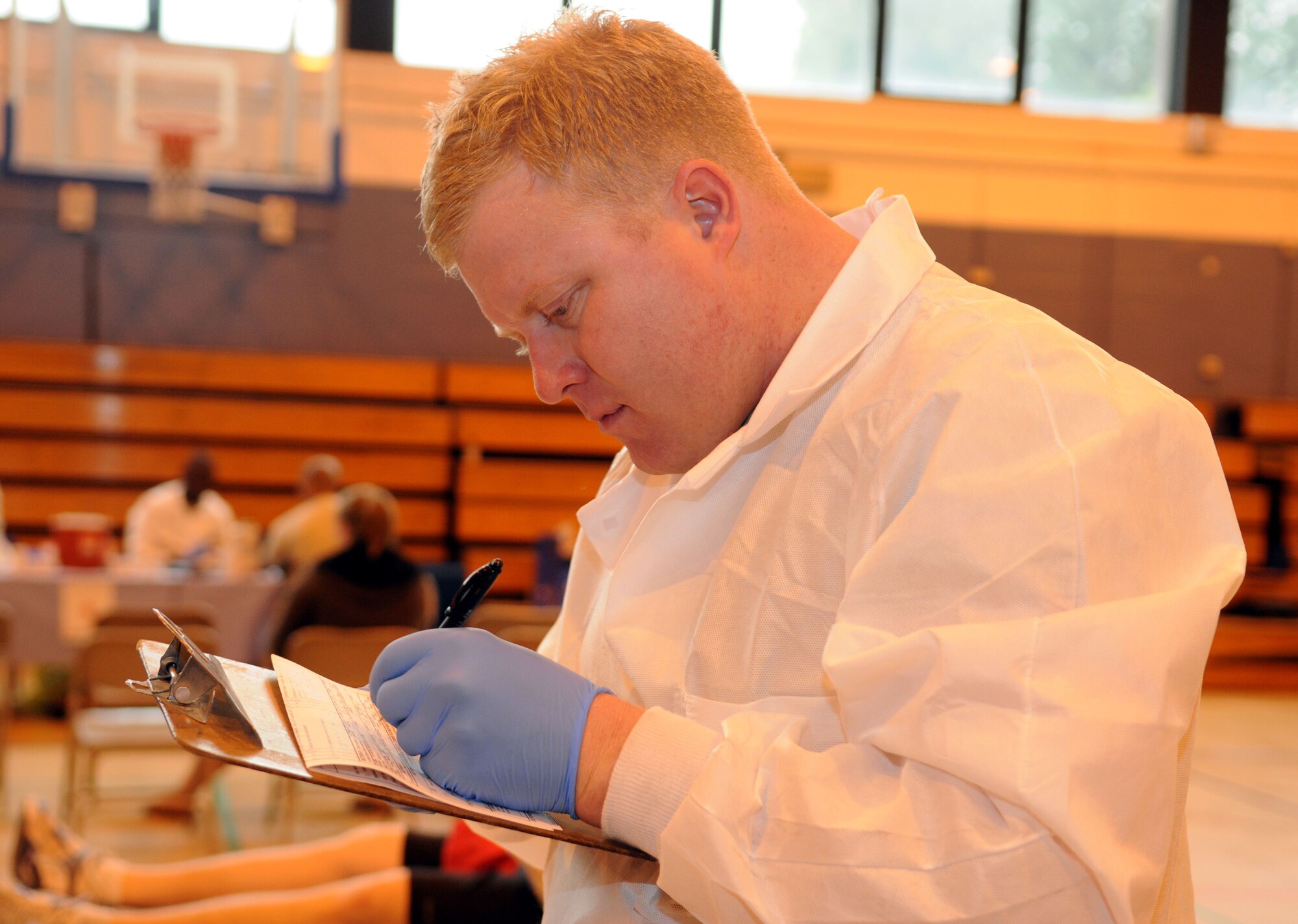 RAF MILDENHALL, England -- Army Sgt. Jerry Smalley, a technician and the blood drive NCO in charge from Landstuhl Regional Medical Center, Germany, annotates information on a blood donor form during the Armed Services Blood Program blood drive at RAF Mildenhall May 11, 2011. The ASBP is a joint operation among the military services to collect blood to be used by Service members and their families. The ASBP holds a blood drive twice a year here. (U.S. Air Force photo/Airman 1st Class Rachel Waller)