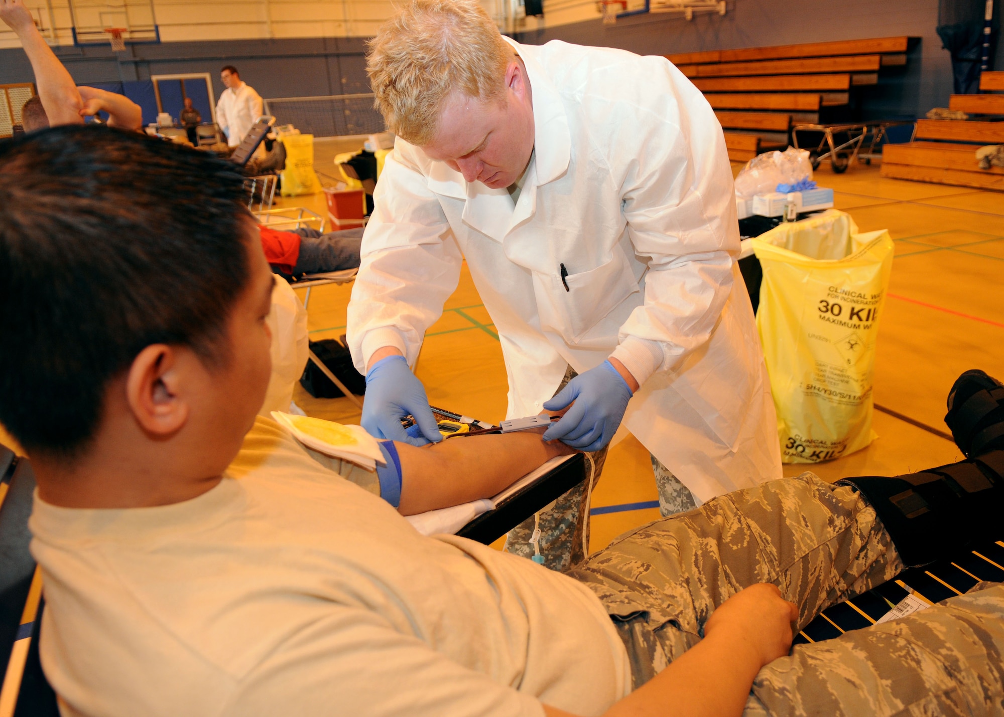 RAF MILDENHALL, England -- Army Sgt. Jerry Smalley, a technician and the blood drive NCO in charge from Landstuhl Regional Medical Center, Germany, adjusts a needle in Staff Sgt. Rogelio Paran, Jr.?s arm, during the Armed Services Blood Program blood drive at RAF Mildenhall May 11, 2011. The ASBP is a joint operation among the military services to collect blood to be used by Service members and their families. This was Sergeant Paran?s first time donating blood. (U.S. Air Force photo/Airman 1st Class Rachel Waller)
