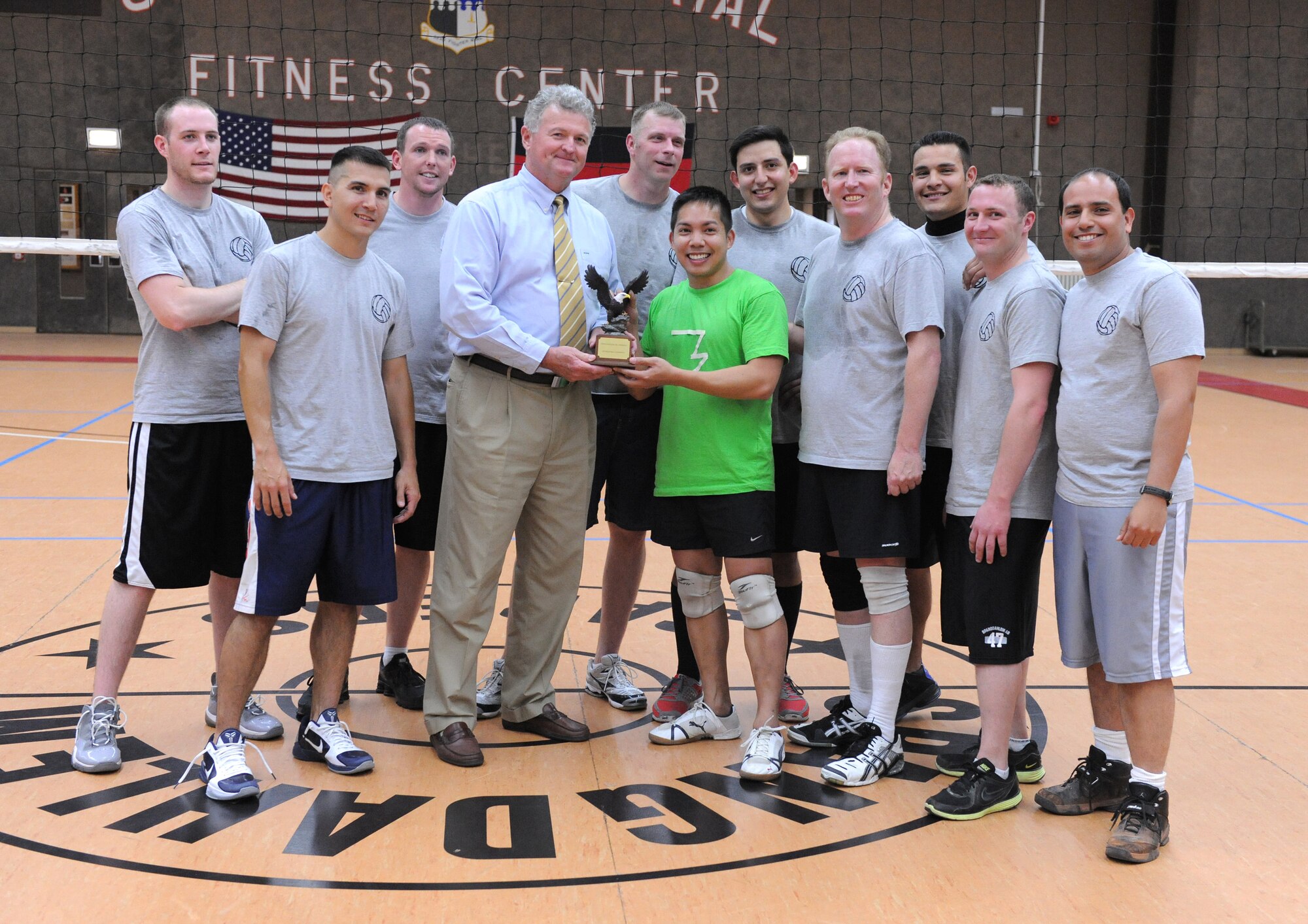 SPANGDAHLEM AIR BASE, Germany –Woodrow Wilson, 52nd Force Support Squadron deputy commander, presents the 52nd Fighter Wing Intramural Volleyball League trophy to the 52nd Civil Engineer Squadron here May 9. The CES defeated the 52nd Medical Group 25-16, 19-25, 15-10 to become the intramural volleyball champions. (U.S. Air Force photo/Senior Airman Nathanael Callon)