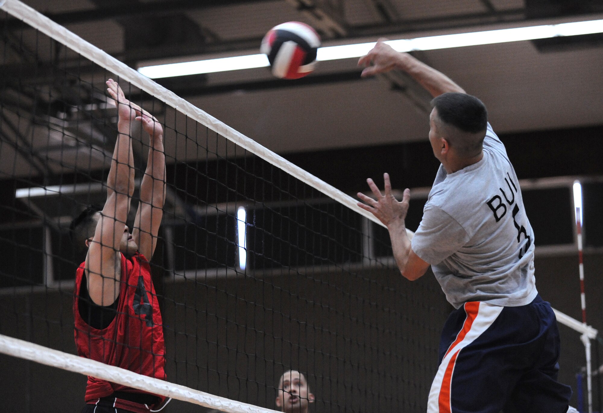 SPANGDAHLEM AIR BASE, Germany – Tuan Bui, 52nd Civil Engineer Squadron, spikes the ball over Scott Whipple, 52nd Medical Group, during the intramural volleyball championship series here May 9. The CES defeated MDG 25-16, 19-25, 15-10 to become the intramural volleyball champions. (U.S. Air Force photo/Senior Airman Nathanael Callon)