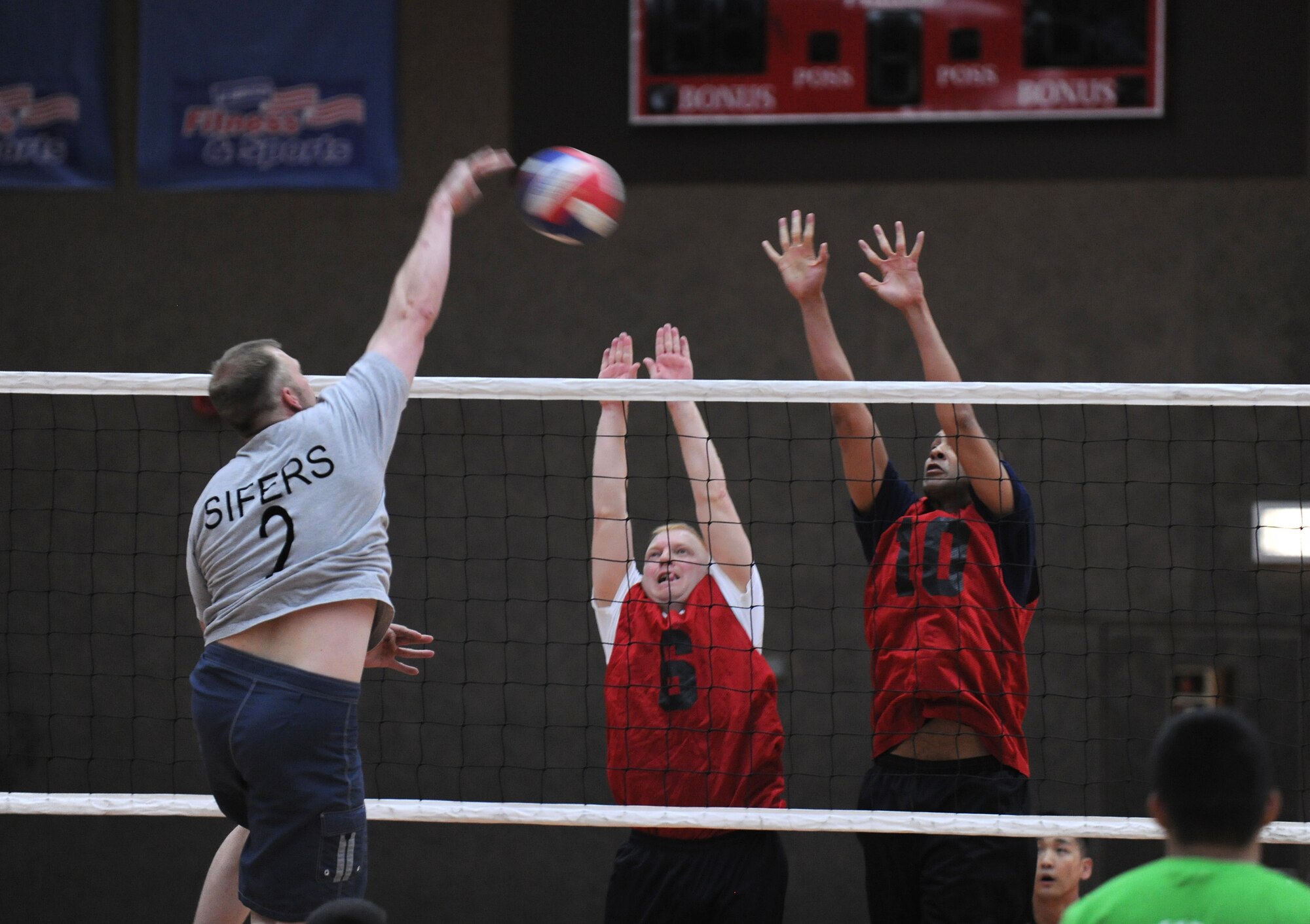 SPANGDAHLEM AIR BASE, Germany – Eric Sifers, 52nd Civil Engineer Squadron, spikes the ball as 52nd Medical Group defenders attempt to block the shot during the intramural volleyball championship series here May 9. The CES defeated MDG 25-16, 19-25, 15-10 to become the intramural volleyball champions. (U.S. Air Force photo/Senior Airman Nathanael Callon)
