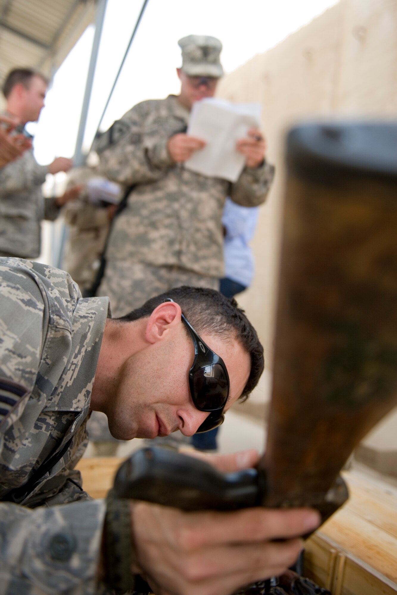 ALI AIR BASE, Iraq -- Staff Sgt. Arron Lopez, 321st Expeditionary Mission Support Advisory Group base transition team member, verifies the serial number of an AK-47 assault rifle April 27. The weapons were delivered to open an Iraqi air force armory so the Iraqis can provide their own base security. Sergeant Lopez is deployed from Luke Air Force Base, Ariz., and is a native of Sacramento, Calif. (U.S. Air Force photo by Staff Sgt. Levi Riendeau)
