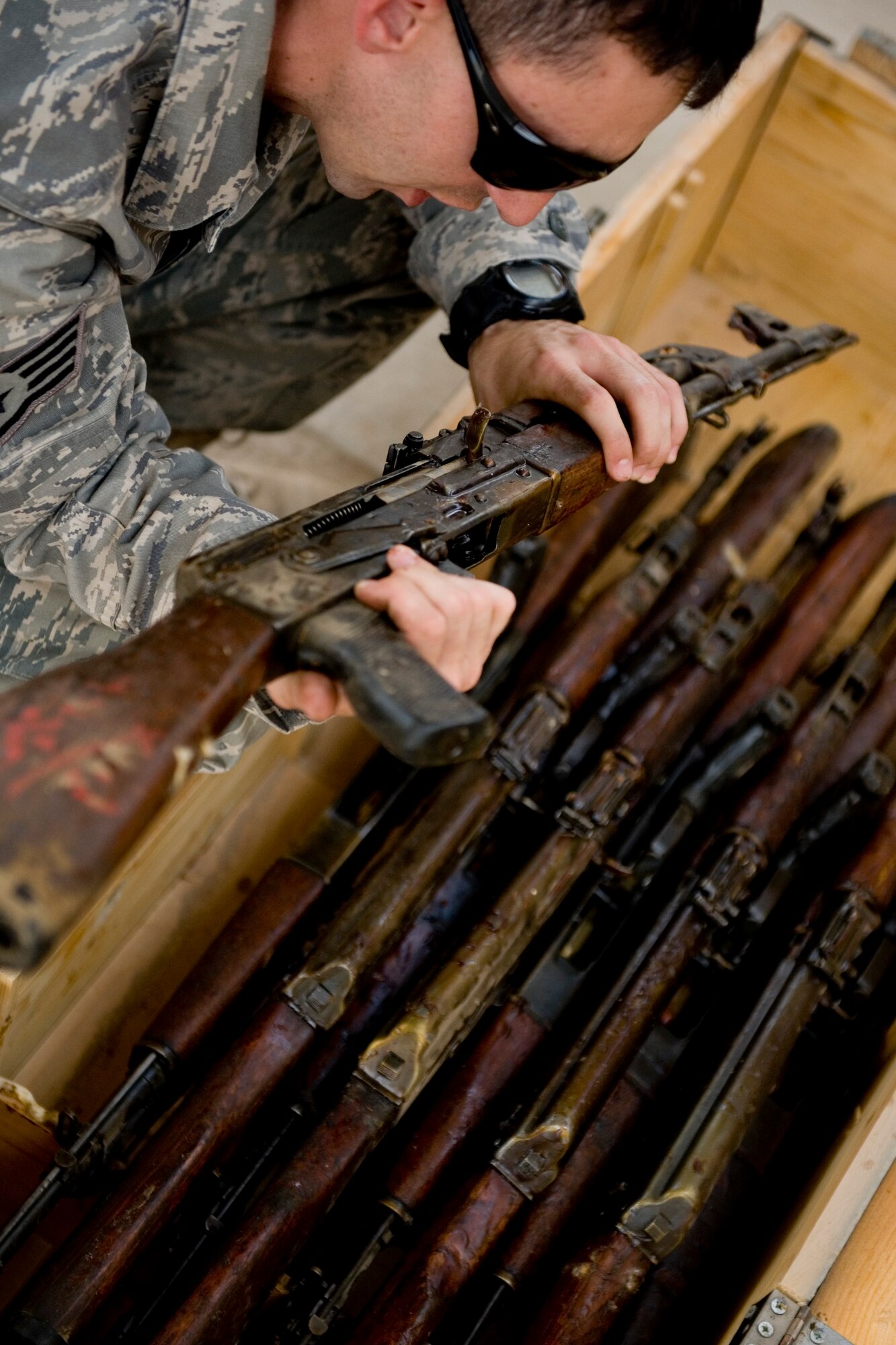 ALI AIR BASE, Iraq -- Staff Sgt. Arron Lopez, 321st Expeditionary Mission Support Advisory Group base transition team member, verifies the serial number on an AK-47 assault rifle April 27. The weapons were delivered to open an Iraqi air force armory so the Iraqis can provide their own base security. Sergeant Lopez is deployed from Luke Air Force Base, Ariz., and is a native of Sacramento, Calif. (U.S. Air Force photo by Staff Sgt. Levi Riendeau)
