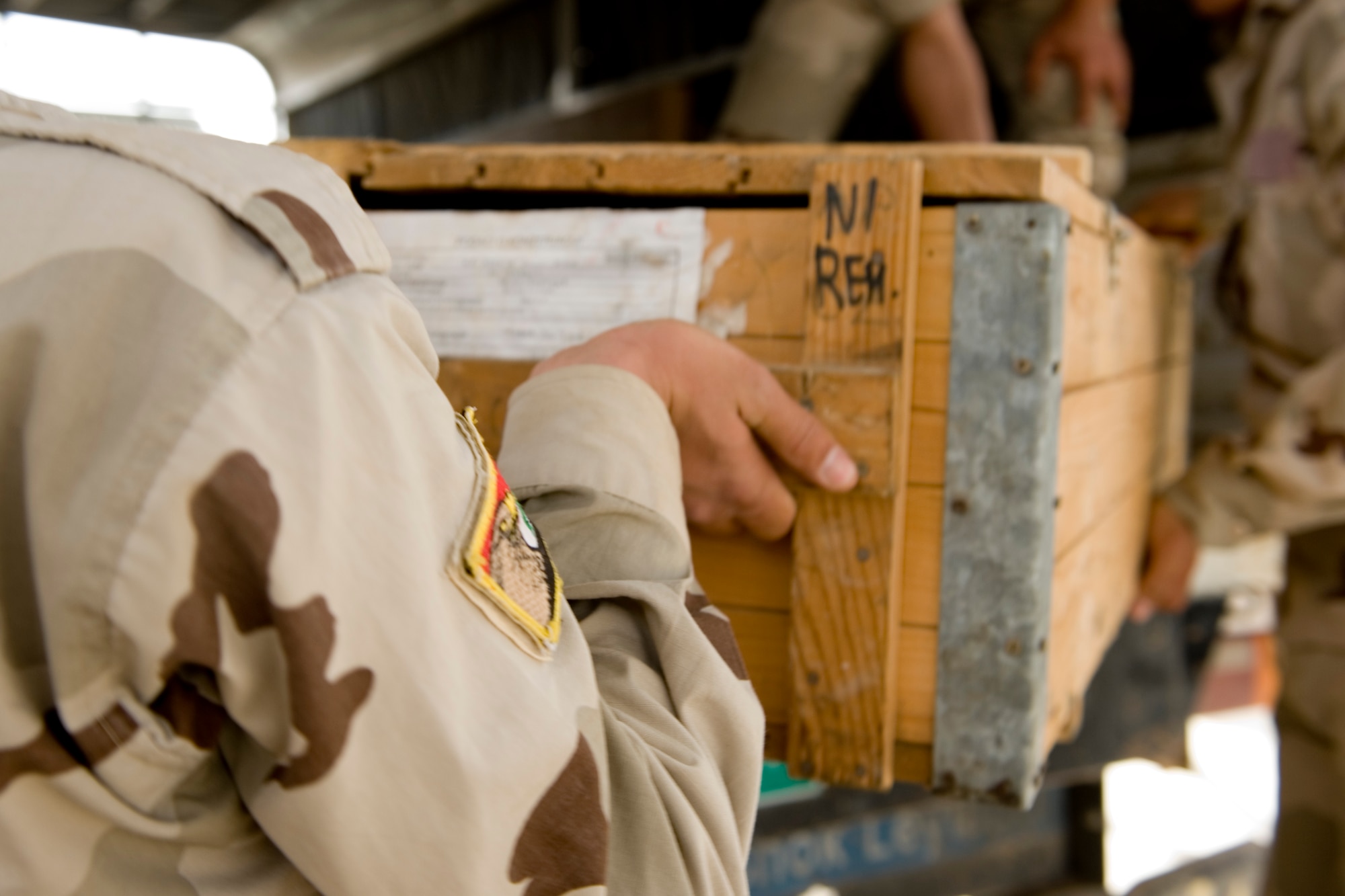 ALI AIR BASE, Iraq -- Iraqi airmen place a crate of AK-47 assault rifles into the back of a truck after verifying serial numbers April 27. The weapons were delivered as part of the process for opening an Iraqi air force armory so the Iraqis can provide their own base security. (U.S. Air Force photo by Staff Sgt. Levi Riendeau)