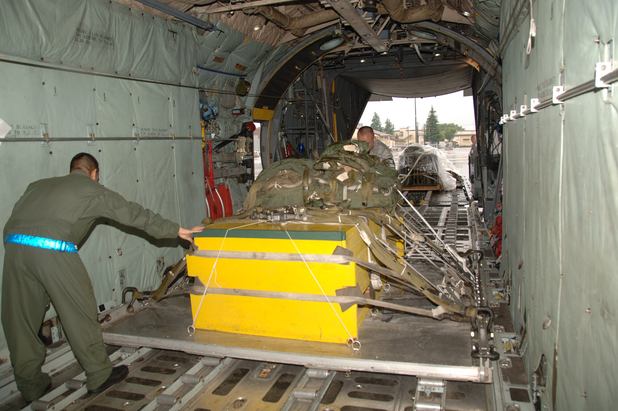 YOKOTA AIR BASE,Japan – Loadmasters from the 36th Airlift Squadron, load equipment pallets onto a C-130 plane in preparation for the 2011 Air Mobility Command Rodeo competition, here, May 11,2011. The competition will take place July 23-29 at Joint-Base Lewis-McChord, Wash., and will allow Airmen within AMC to display their wing's ability to perform critical wartime skills including aircrew operations, combat mobility, maintenance and security forces.(U.S. Air Force photo/Airman 1st Class Lynsie Nichols)