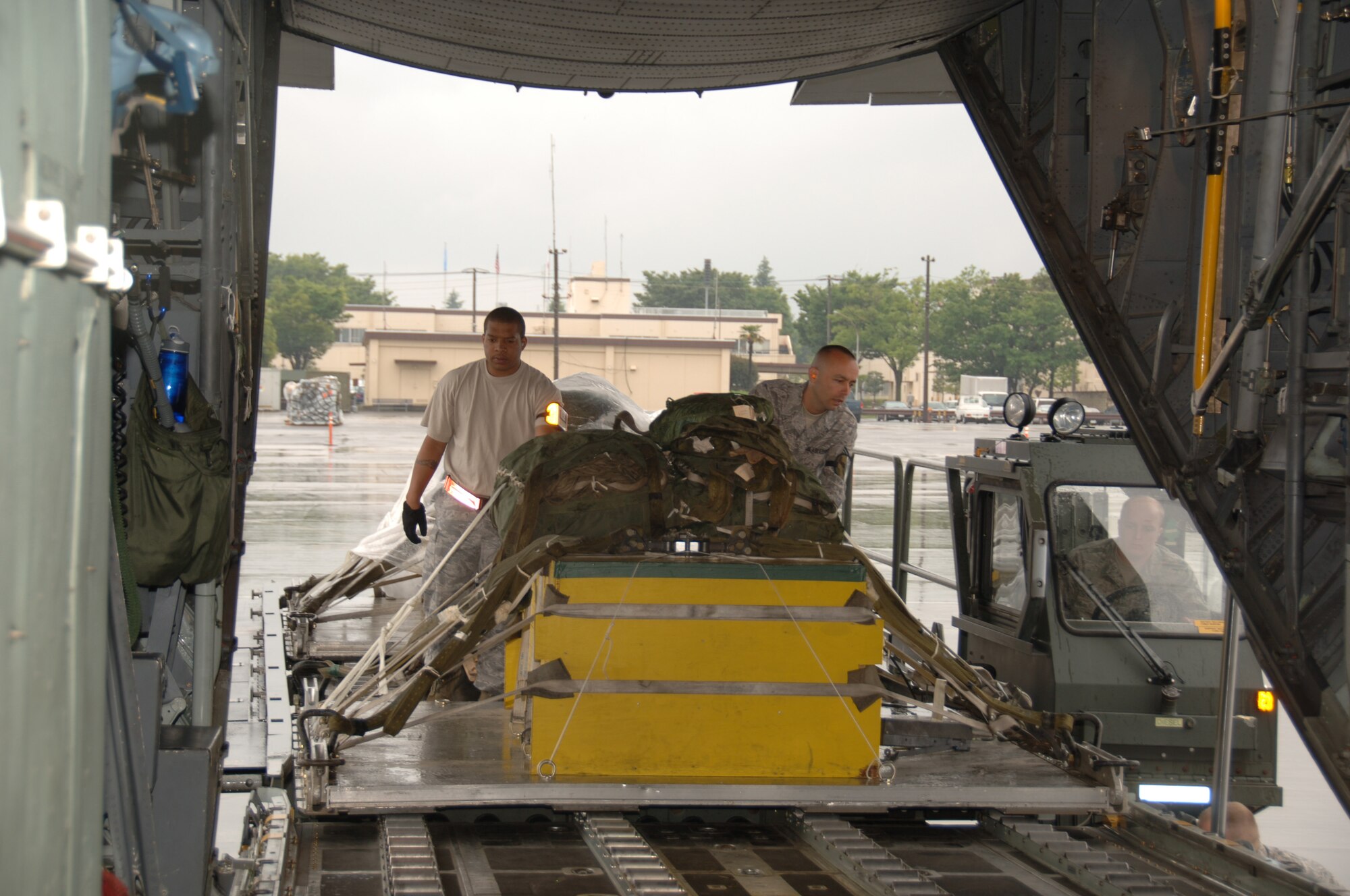 YOKOTA AIR BASE,Japan – Loadmasters from the 36th Airlift Squadron, load equipment pallets onto a C-130 plane in preparation for the 2011 Air Mobility Command Rodeo competition, here, May 11,2011. The competition will take place July 23-29 at Joint-Base Lewis-McChord, Wash., and will allow Airmen within AMC to display their wing's ability to perform critical wartime skills including aircrew operations, combat mobility, maintenance and security forces.(U.S. Air Force photo/Airman 1st Class Lynsie Nichols)