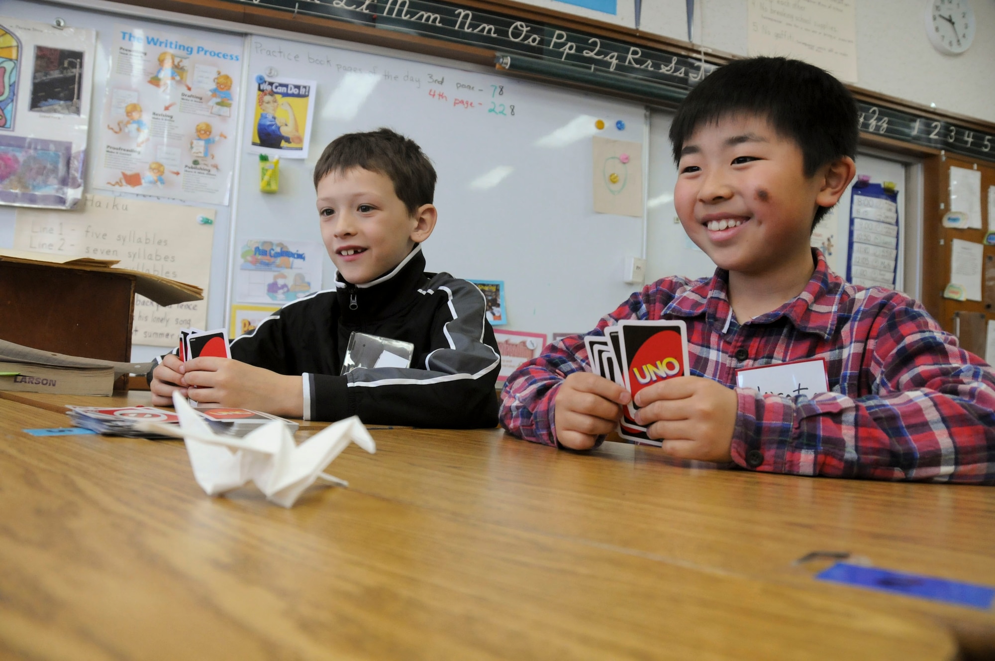 MISAWA AIR BASE, Japan -- Noah Anys, a Cummings Elementary School student, and Hiroto Sawai, an Omagari Elementary School student, enjoy a game of Uno together during a cultural exchange day here, May 10. As part of the exchange, Japanese students were shown numerous American games and activities. (U.S. Air Force photo/Staff Sgt. Rachel Martinez)