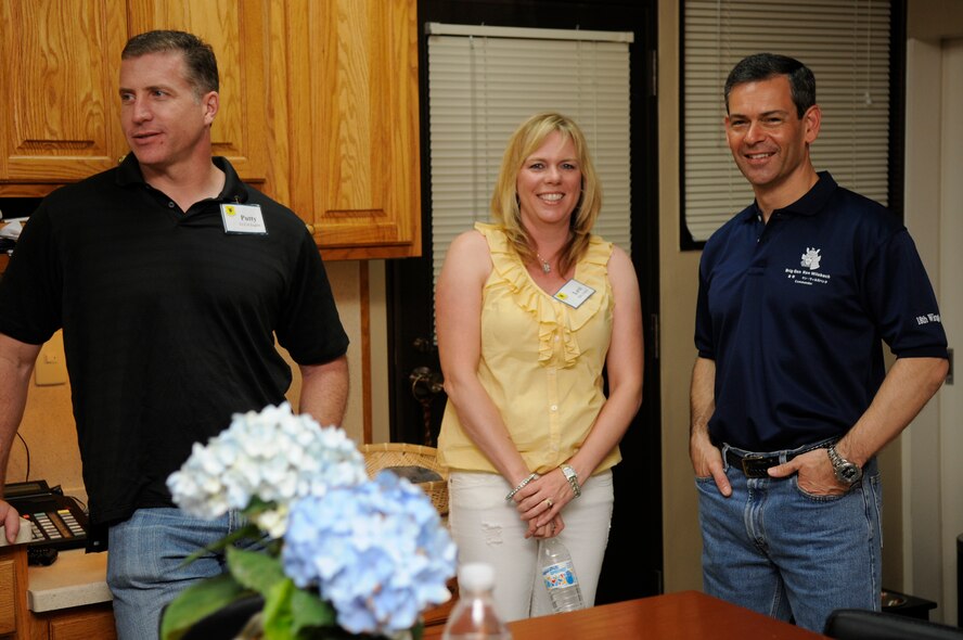 Brig. Gen. Ken Wilsbach, 18th Wing commander, poses with his guests Lt. Col. David Eaglin, 67th Fighter Squadron director of operations and his wife Lexi at General and Mrs. Wilsbach’s “Sweet Sundays” social at the commander’s home, May 8. For nearly two years, the general and his wife have hosted Sweet Sundays to connect with service members on the base in a casual environment. (U.S. Air Force photo/ Airman 1st Class Maeson L. Elleman)