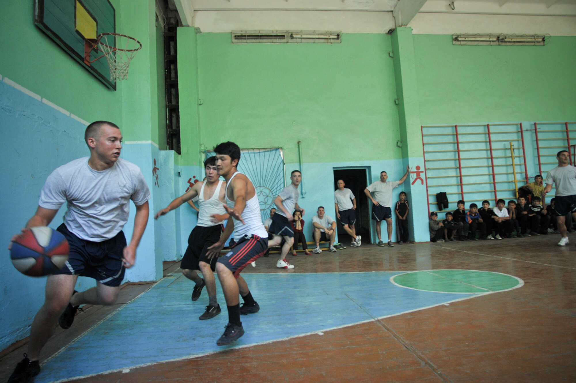 TRANSIT CENTER AT MANAS, Kyrgyzstan -- Transit Center Airmen participate in a friendly "Sports Day" competition with local school students in Sadove village May 9.  Days like this one spent developing teamwork and strengthening friendships through sports such as volleyball, basketball and soccer are a regular part of the Transit Center's outreach with local communities.  (U.S. Air Force photo by Staff Sgt. Stacy Moless)