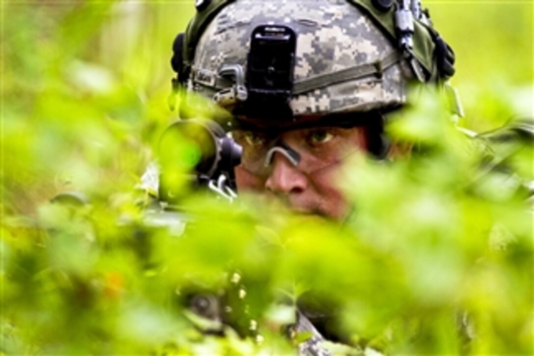 Army Pfc. Dustin Dean provides security behind a machine gun while the rest of his platoon searches a farmhouse for intelligence during a platoon training and evaluation exercise at Fort Bragg, N.C., on April 27, 2011.  Dean is assigned to the 82nd Airborne Division's 1st Brigade Combat Team.  