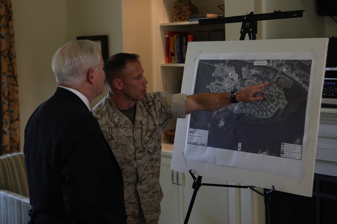 Col. Daniel Lecce (right), commanding officer of Marine Corps Base Camp Lejeune, briefs Secretary of Defense Robert Gates about the path and damage of April 16’s tornado on the Tarawa Terrace housing community at the TT Community Center, May 12. Gates then went on to speak to Marines and sailors of the II Marine Expeditionary Force at the base theater concerning the future of the Marine Corps.