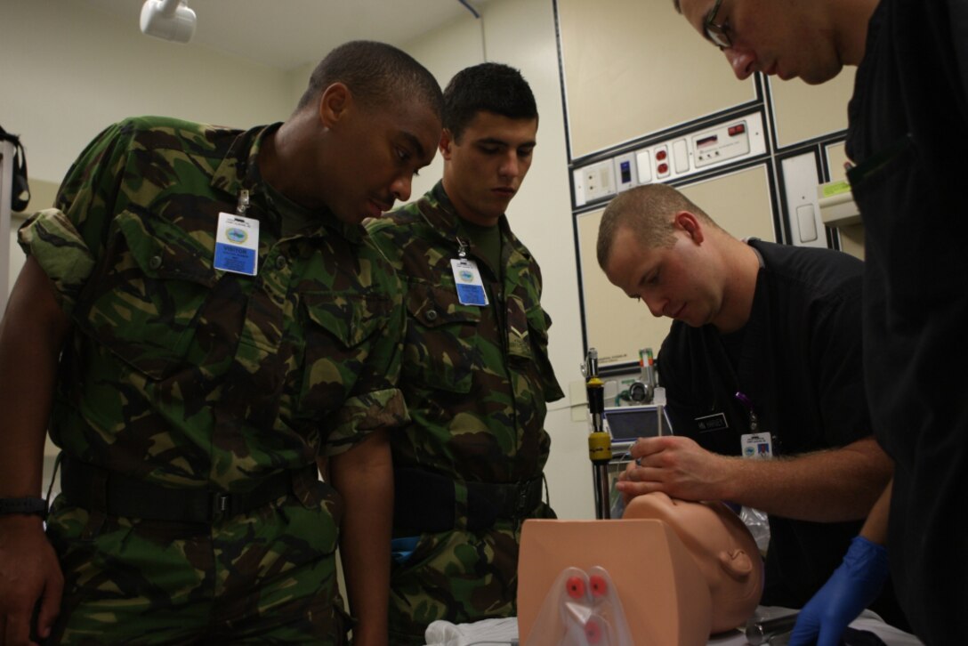 A corpsman with Naval Hospital Camp Lejeune performs an intubation procedure on a dummy head for medical soldiers with the Bermuda Regiment during Exercise Bermuda Warrior aboard Marine Corps Base Camp Lejeune, May 9. Approximately 180 Bermuda Regiment soldiers conducted a two-week training exercise aboard the base in a multitude of operation areas, part of their annual abroad training.