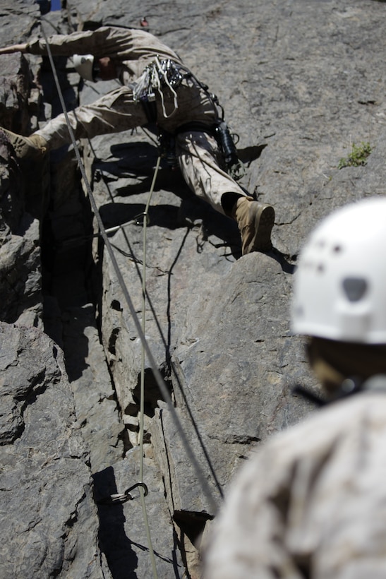 A climber looks down at his partner for assurance that he won’t fall during the Instructor Qualification Course May 11, 2011, in a training area of Marine Corps Mountain Warfare Training Center Bridgeport during the course. Both are students in the course trying to qualify to be a climbing instructor.