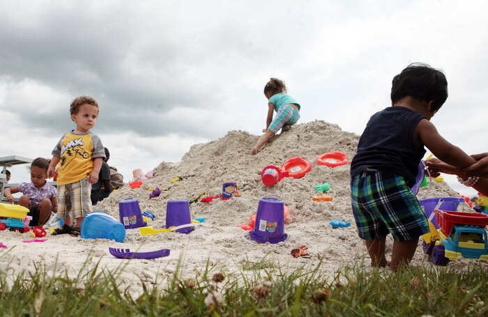 Children play on a mound of sand during 2nd Marine Logistics Group’s Family Day at the Geogtte Field House aboard Camp Lejeune, N.C., May 12, 2011. Family Day is an annual tradition amongst units in the Marine Corp in which Marines and sailors enjoy time off work and come together with their family and friends for a day of recreation, food and shows. (U.S. Marine Corps photo by Pfc. Franklin E. Mercado)
