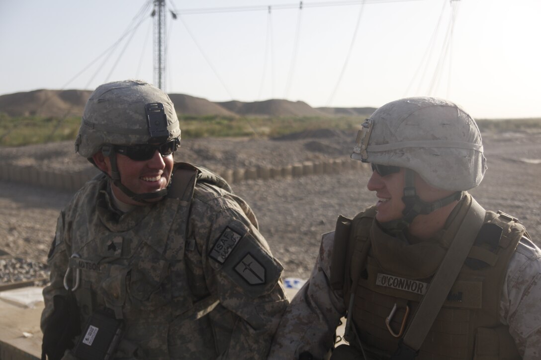 U.S. Army Sgt. Joshua Matson talks with Sgt. Jonathan O’Connor with Marine Wing Support Squadron 272 during a shift transfer at Combat Outpost Payne, Afghanistan, May 12. A half dozen Marine combat engineers from Marine Wing Support Squadron 272, based out of Marine Corps Air Station New River, N.C., assist the U.S. Army in performing preventative maintenance on the boats and trucks, manning guard posts, assisting the convoys with getting across the bridge and monitoring the conditions of the river. O’Connor is a combat engineer with MWSS-272 and the bridge noncommissioned officer in charge for Marine Wing Support Squadron-272 at COP Payne.