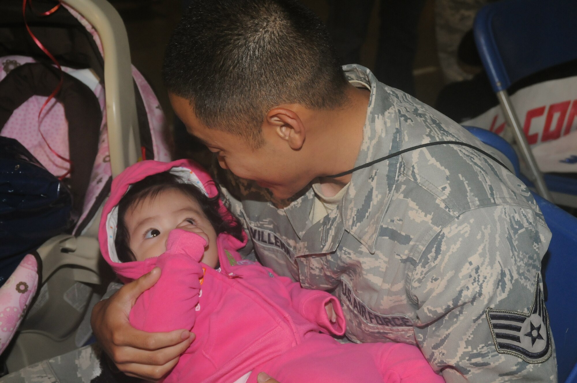 MISAWA AIR BASE, Japan -- Staff Sgt. Jade Villena, 35th Aircraft Maintenance Squadron, plays with his 7-month-old daughter, Ashleigh, after returning home, May 13. More than 300 Airmen from Misawa Air Base returned home from a seven-and-a-half-month deployment this week. (U.S. Air Force photo/Staff Sgt. Rachel Martinez)