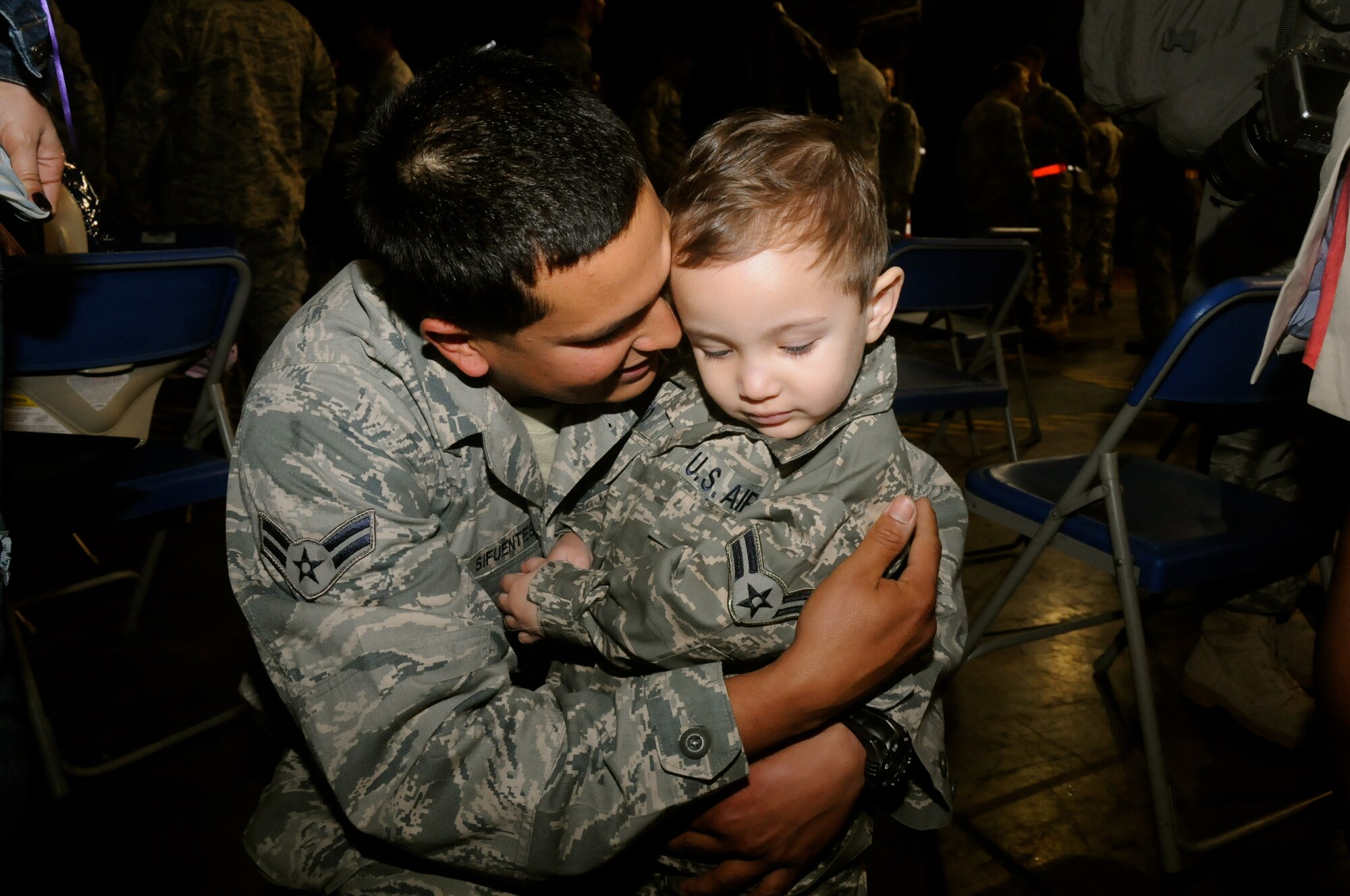 MISAWA AIR BASE, Japan -- Airman 1st Class Jose Resto Sifuentes, 35th Aircraft Maintenance Squadron, hugs his son Derek, wearing a matching uniform, after returning home, May 13. More than 300 Airmen from Misawa Air Base returned home from a seven-and-a-half-month deployment this week. (U.S. Air Force photo/Staff Sgt. Rachel Martinez)