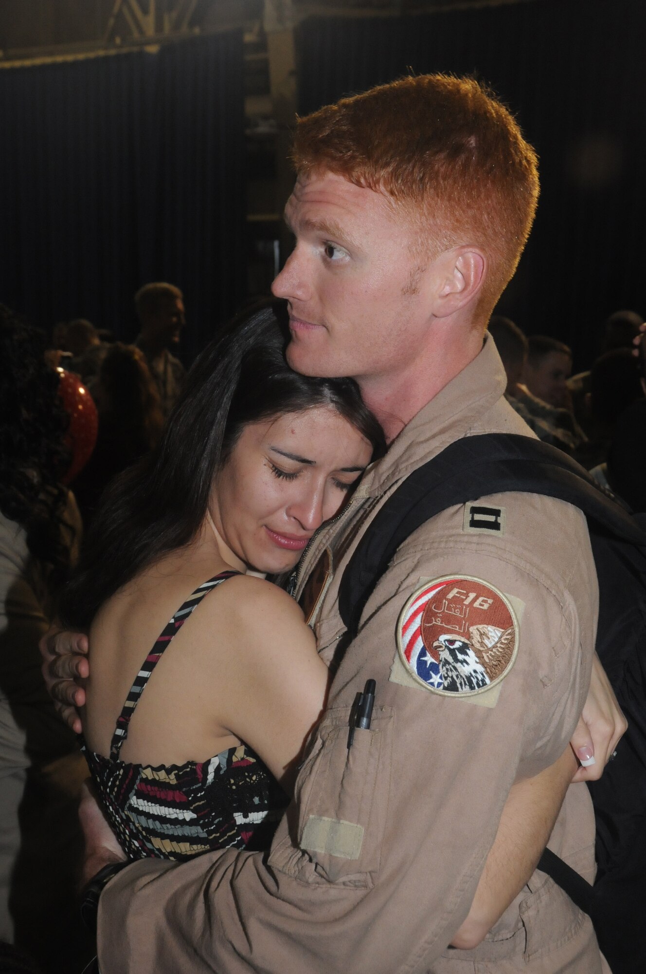 MISAWA AIR BASE, Japan -- Capt. Ryan Busbey, 13th Fighter Squadron pilot, holds his wife, Laura, after returning to home, May 13. Captain Busbey and more than 300 other Airmen from Misawa Air Base were deployed to the Air Force’s Central area of responsibility for nearly eight months. (U.S. Air Force photo/Staff Sgt. Rachel Martinez)