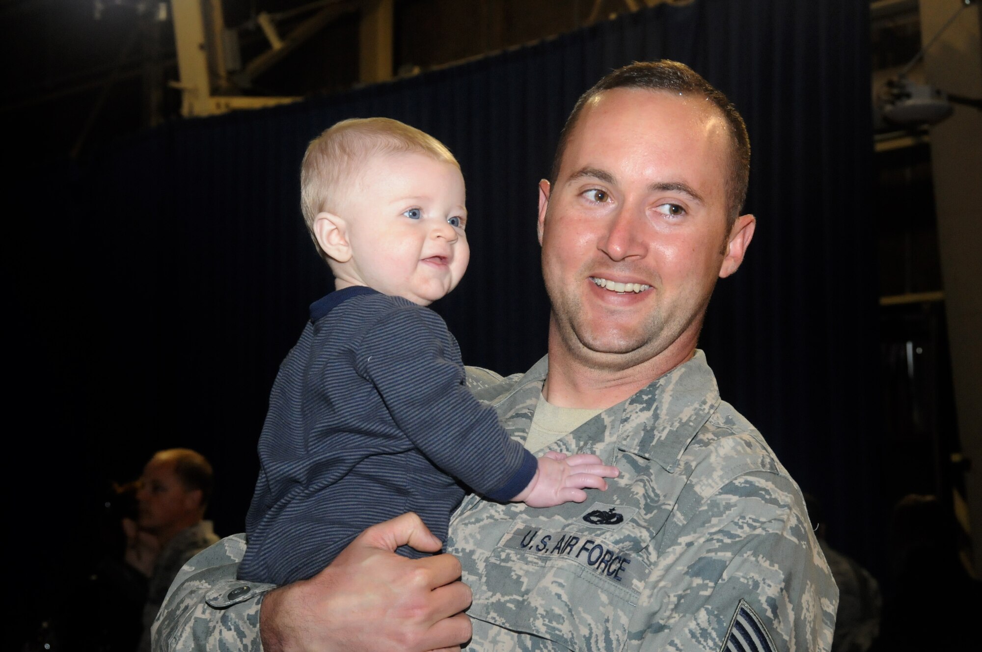MISAWA AIR BASE, Japan -- Tech. Sgt. Kenneth Gardner, 35th Aircraft Maintenance Squadron, poses for a photo with his 6-month-old son, Kentom, upon returning from a deployment, May 13. Sergeant Gardner deployed just prior to his first son’s birth. (U.S. Air Force photo/Staff Sgt. Rachel Martinez)