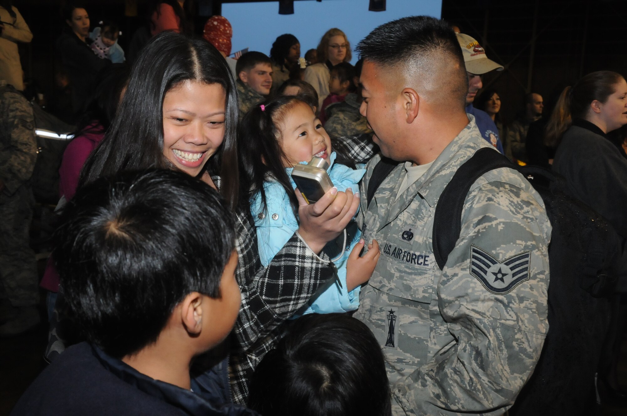MISAWA AIR BASE, Japan -- Staff Sgt. Sherwyn Mabute, 35th Aircraft Maintenance Squadron, reunites with his family following a seven-and-a-half-month deployment, May 13. Sergeant Mabute was one of nearly 300 Airmen assigned to the 35th Maintenance and Operations Groups to return home with the main body of deployers. (U.S. Air Force photo/Staff Sgt. Rachel Martinez)