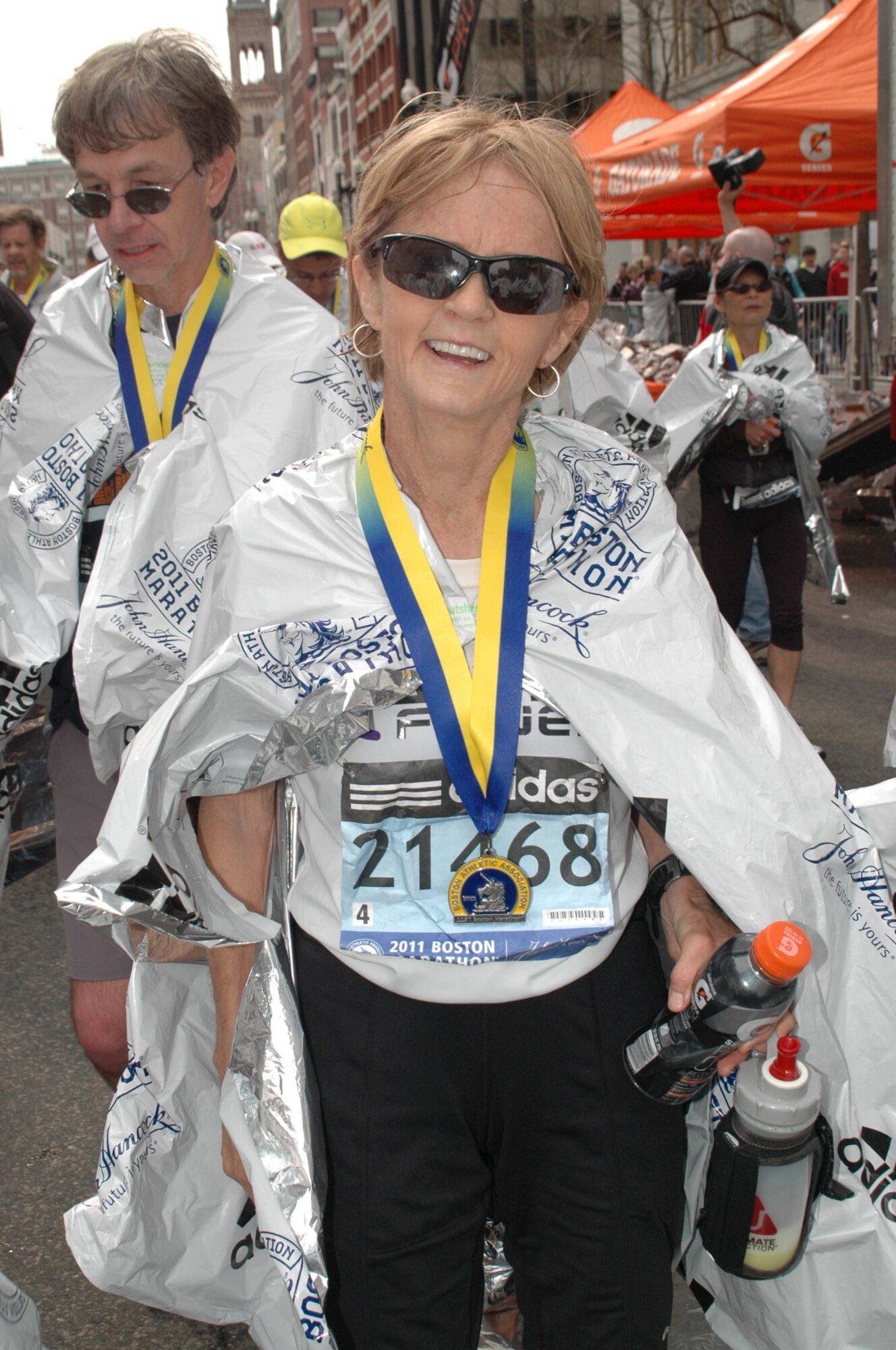 DAVIS-MONTHAN AIR FORCE BASE, Ariz. – Nancy Rickert, the thrift shop bookkeeper on base, poses for a picture with her medal after completing the 2011 Boston Marathon. Ms. Rickert finished the marathon eighth in her age group.