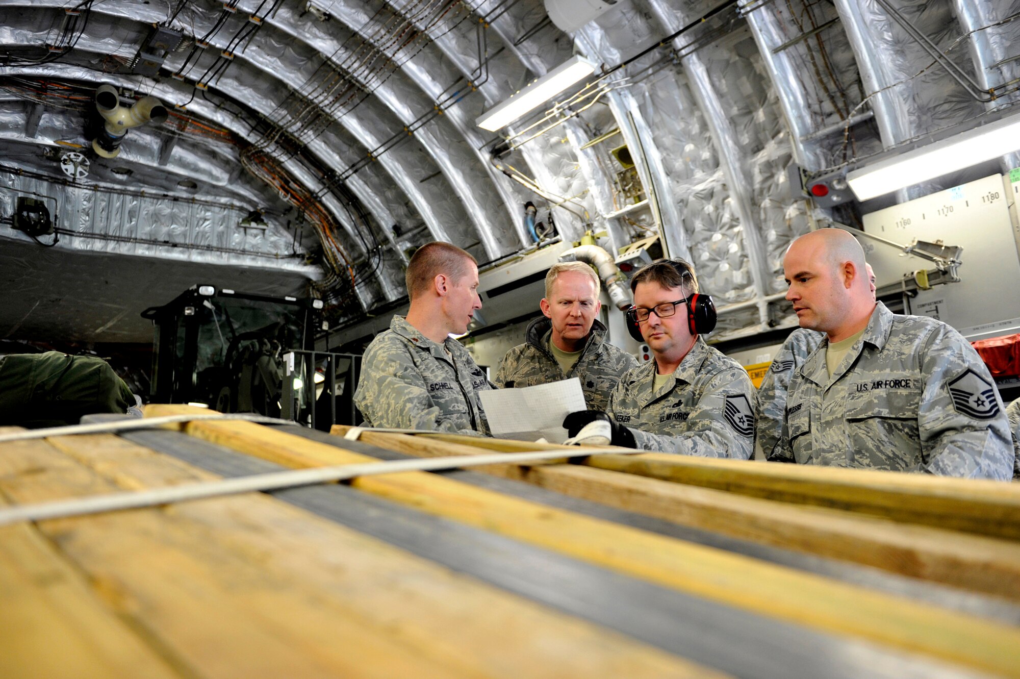 Maj. Matthew Schnell, Lt. Col. Lee Wingfield, Master Sgt. John Meeker, and Master Sgt. Jereck Duplessis  coordinate off-load operations upon arrival May 9, 2011, at Mihail Kogalniceanu Air Base, Romania. Fifty-four members of the 621st Contingency Response Wing deployed here to extend airfield capability supporting multi-modal operations during a U.S. Transportation Command proof-of-principle evaluation. The process is expected to demonstrate the feasibility of using the air base as a hub for equipment flowing into and out of Afghanistan. Major Schnell, Colonel Wingfield, Sergeants Meeker and Duplessis are assigned to the 621st Contingency Response Element. (U.S. Air Force photo/Master Sgt. Laura K. Deckman)