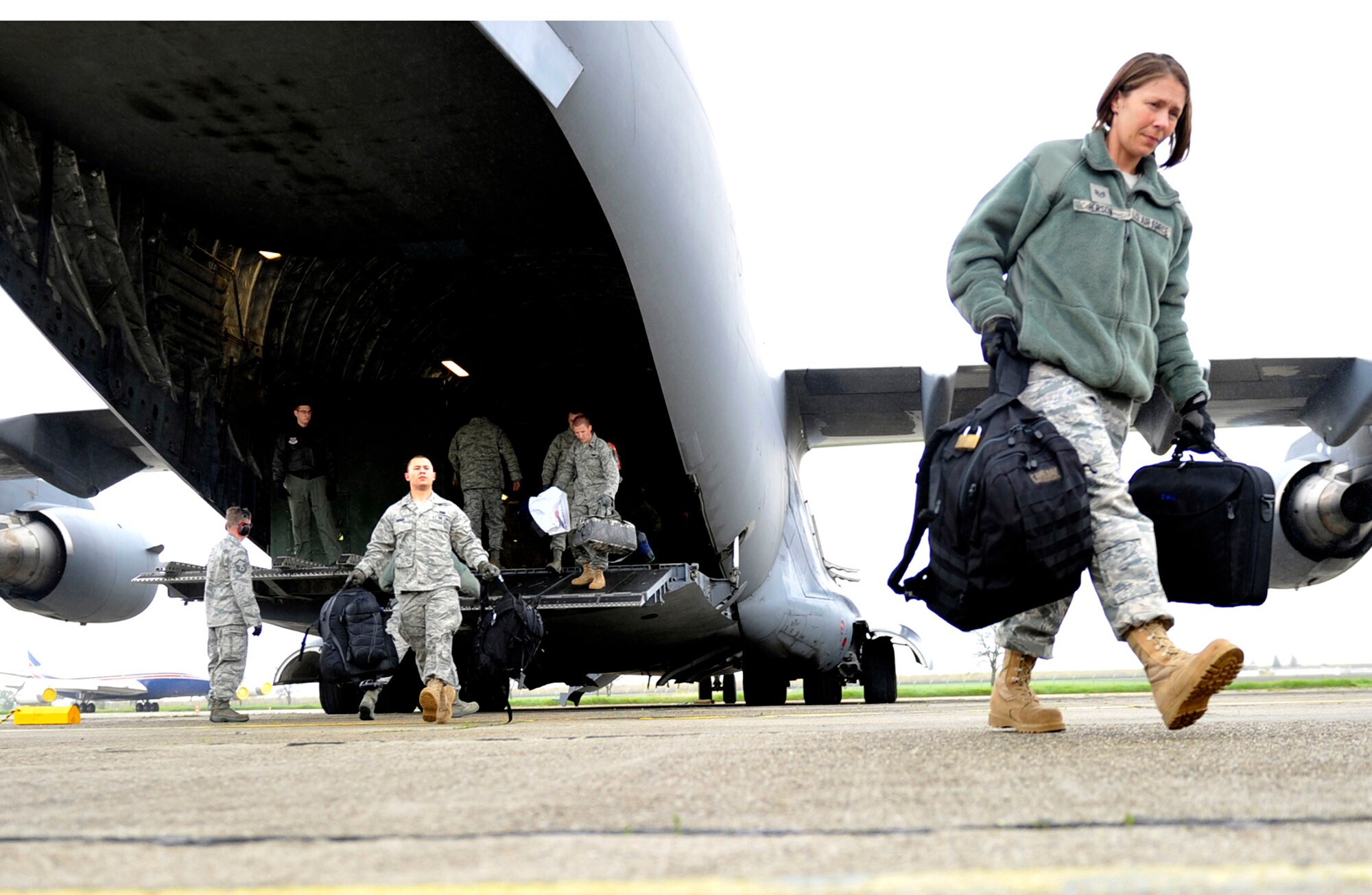 Members of the 621st Contingency Response Element off-load a C-17 Globemaster III upon arrival May 9, 2011, at Mihail Kogalniceanu Air Base, Romania. Fifty-four members of the 621st Contingency Response Wing deployed here to extend airfield capability supporting multi-modal operations during a U.S. Transportation Command proof-of-principle evaluation. The process is expected to demonstrate the feasibility of using the air base as a hub for equipment flowing into and out of Afghanistan. (U.S. Air Force photo/Master Sgt. Laura K. Deckman) 