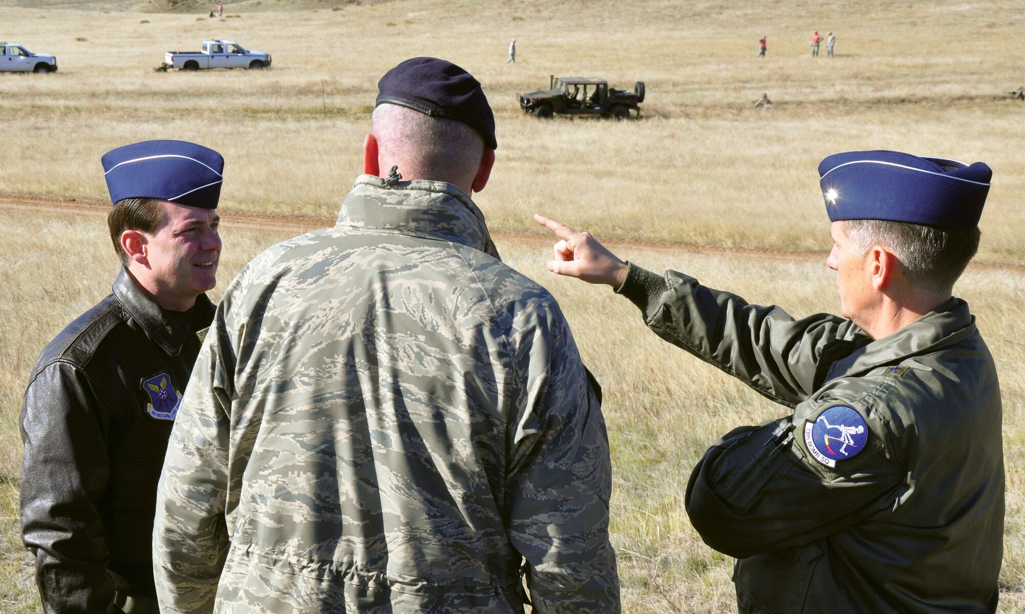 Brig. Gen. Jeffry Smith, Air Force Global Strike Command Director of Plans, Programs and Requirements, Col. Steve Miller, 90th Security Forces Group commander, and Brig. Gen. Timothy Ray, AFGSC Director of Operations, discuss integrated operations during an exercise at Camp Guernsey, Wyo., May 5. The generals’ visit focused on the tactical integrated operations of ground forces and helicopter support to sustain nuclear security. (U.S. Air Force photo by Senior Airman Daryl Knee)