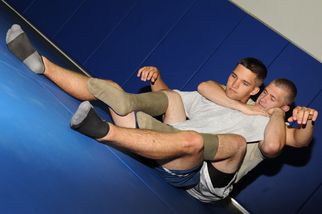 Airman 1st Class James Gillispie, 10th Intelligence Squadron link system technician, performs a jiu jitsu move on Airman 1st Class Logan Malaney, 10th Intelligence Squadron transmissions technician, during a demonstration at Langley Air Force Base, Va., May 11, 2011. The jiu jitsu demonstration is one of various activities being held during May Fitness Month. (U.S. Air Force photo/Airman 1st Class Teresa Zimmerman)(RELEASED)