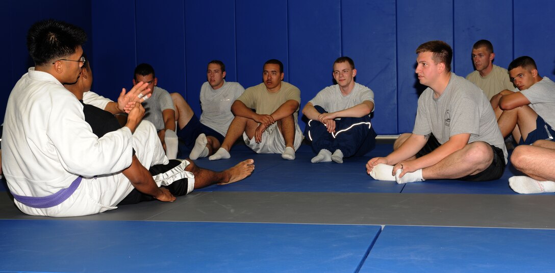 Staff Sgt. Christopher Costa, jiu jitsu instructor, demonstrates a defensive move on Staff Sgt. Marcellous Register, 440th Supply Chain Operations Squadron personnelist at Langley Air Force Base, Va., May 11, 2011. The jiu jitsu demonstration is one of various activities being held during May Fitness Month. (U.S. Air Force photo/Airman 1st Class Teresa Zimmerman)(RELEASED)