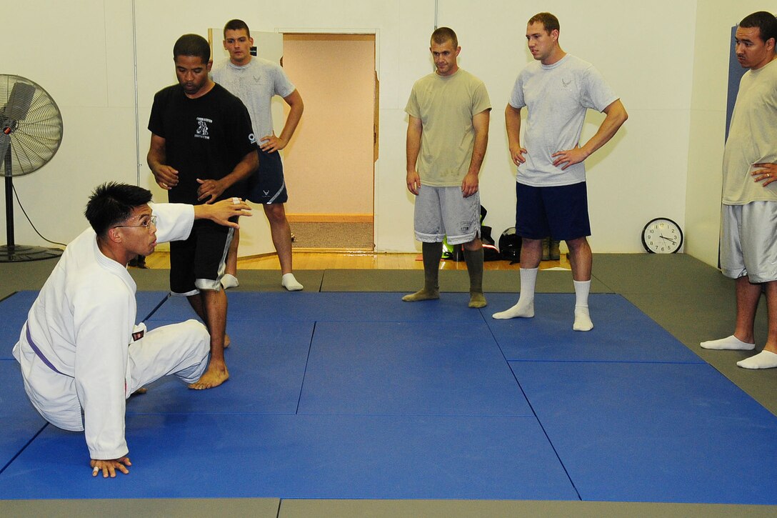 Jiu jitsu instructor Staff Sgt. Christopher Costa, 10th Intelligence Squadron link systems shift lead, demonstrates a stand up maneuver during a jiu jitsu demonstration at Langley Air Force Base, Va., May 11, 2011. The demonstration was held as a way to give members of Team JBLE, and their dependents, an opportunity to experience the class before signing up. (U.S. Air Force photo by Staff Sgt. Ashley Hawkins)(RELEASED)