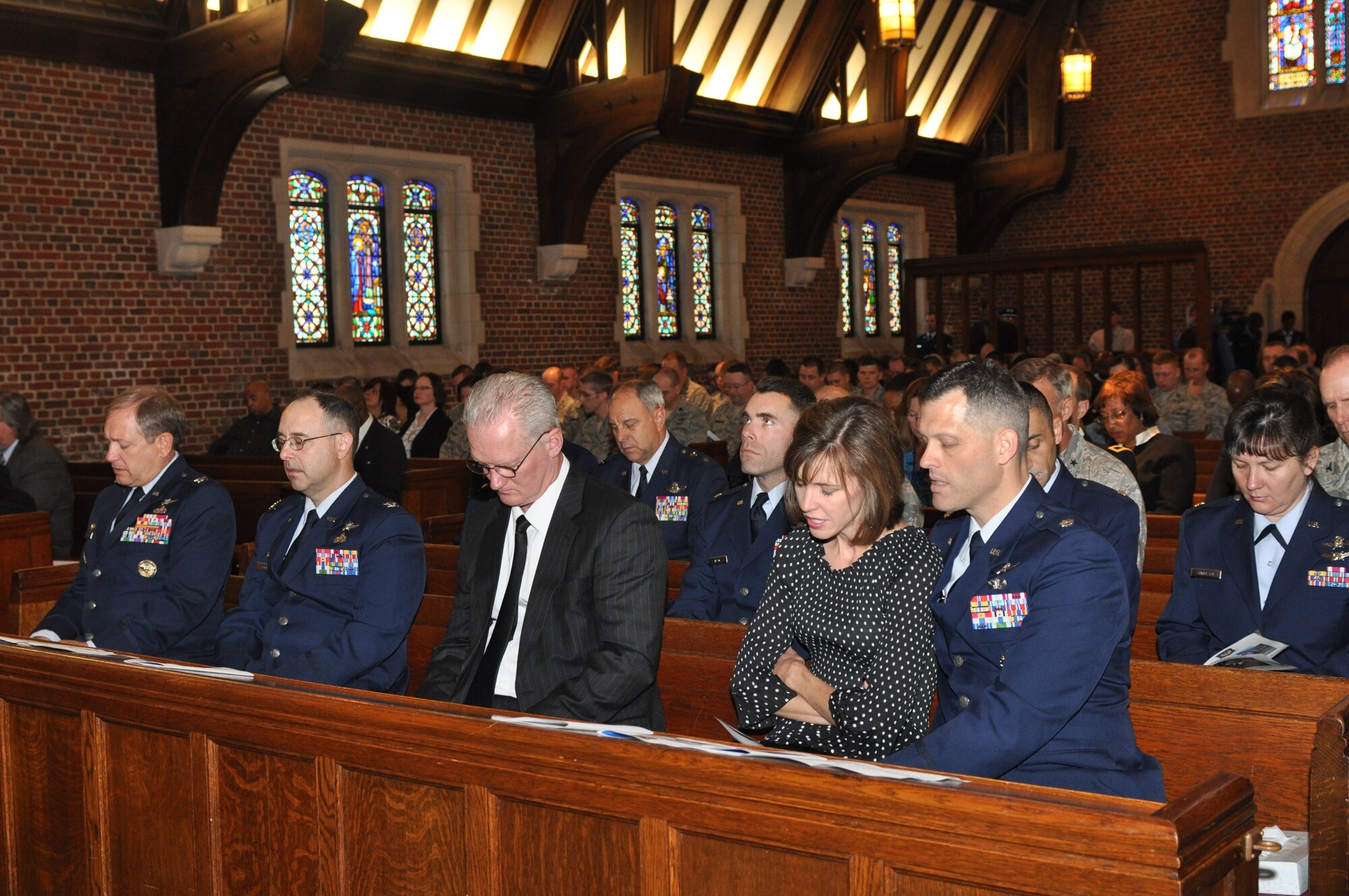 Mourners sing the Air Force Hymn during a memorial service celebrating the life of  Maj. Charles Ransom, who was assigned to the 83d Network Operations Squadron as a flight commander, at Langley Air Force Base, Va., May 12, 2011. Major Ransom managed projects directed by Headquarters Air Force, the Air Force Network Integration Center and Air Force Space Command, supporting six major commands and 350,000 Air Force network users. (U.S. Air Force photo by Tech. Sgt. April Wickes)(RELEASED) 
