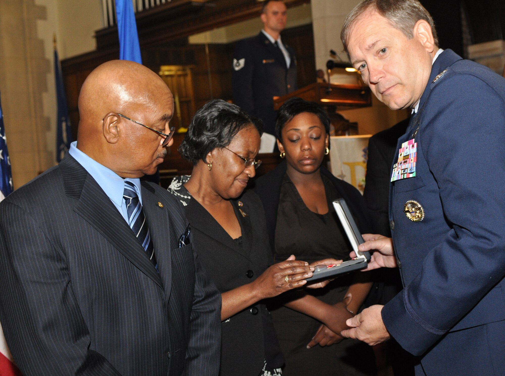 Col Kevin B. Wooton, 67th Network Warfare Wing commander, presents Mr. Willie Ransom, Mrs. Marysue Ransom and Ms. Naquita Marie Bassfield, with a Bronze Star medal awarded posthumously to Maj. Charles Ransom during his memorial service at Langley Air Force Base, Va., May 12, 2011. Major Ransom was assigned to the 83d Network Operations Squadron as a flight commander, and lead a 19-member flight providing squadron planning of a $6.4 million budget to accomplish deployed and in-garrison Air Force Network Operations missions. His family also received a Meritorious Service Medal and Purple Heart in his honor. (U.S. Air Force photo by Tech. Sgt. April Wickes)(RELEASED)