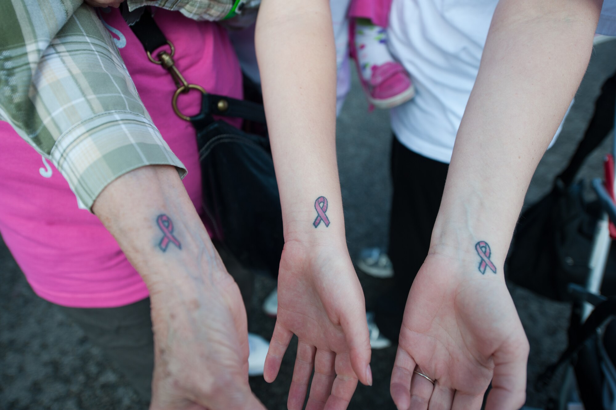 Left to right, Vera Bowman, Carolyn Lyon and Jen Navarro display tattoos they received last year in celebration of Vera surviving cancer as they participate in the 2011 annual Susan G. Komen Race for the Cure in Boise, Idaho, May 7th. All three are participating as part of the Idaho National Guard’s official team, “Guardians.” The Guardians team includes 13 participants from various units of both the Idaho Army and Air National Guard.