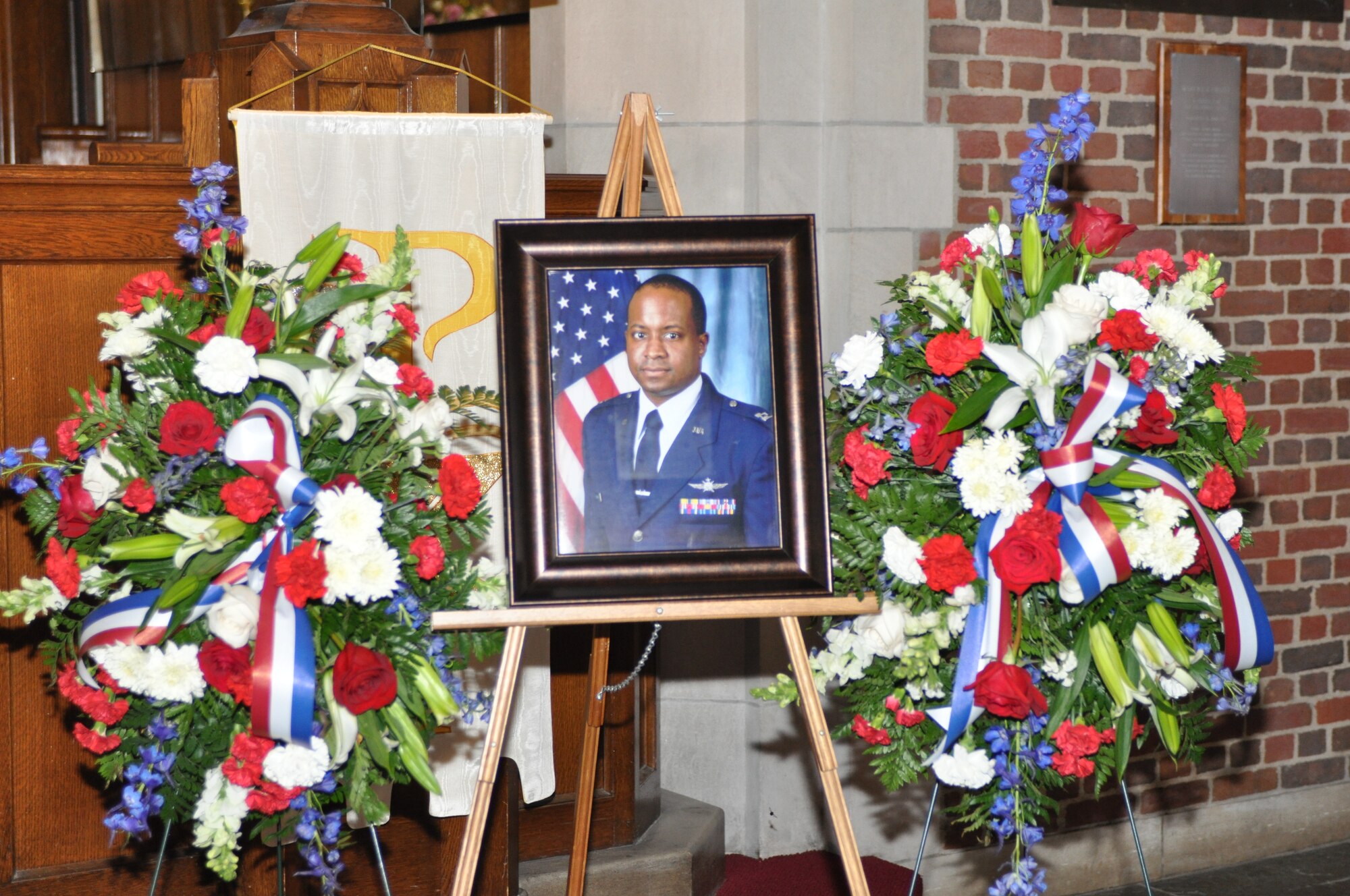 A photo of Maj. Charles Ransom is displayed during the memorial service in his honor at Langley Air Force Base, Va., May 12, 2011. Major Ransom was assigned to the 83d Network Operations Squadron as a flight commander, and lead a 19-member flight providing squadron planning of a $6.4 million budget to accomplish deployed and in-garrison Air Force Network Operations missions. He died April 27, at the Kabul International Airport, Afghanistan, of wounds suffered from gunfire. (U.S. Air Force photo by Tech. Sgt. April Wickes)(RELEASED) 

