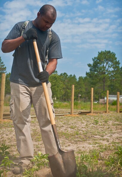 QUITMAN, Ga. -- Staff Sgt. Christopher Watson, 41st Helicopter Maintenance Unit HH-60 Pave Hawk crew chief, shovels dirt into a fence post at the Hopes and Dreams Riding Facility May 11. The facility provides a place where servicemembers with post-traumatic stress disorder can relax and talk about their problems. (U.S. Air Force photo/Airman 1st Class Jarrod Grammel)