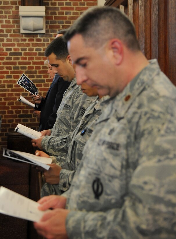 Mourners sing the Air Force Hymn during a memorial service celebrating the life of Maj. Raymond Estelle at the Langley Chapel at Langley Air Force Base, Va., May 11, 2011. Major Estelle, an Airman assigned to Headquarters Air Combat Command, died April 27 at the Kabul International Airport, Afghanistan, of wounds suffered from gunfire. Major Estelle was a native of New Haven, Conn., who served as a cyberspace operations officer with Headquarters Air Combat Command. (U.S. Air Force photo/Senior Airman Antoinette Gibson)(RELEASED)