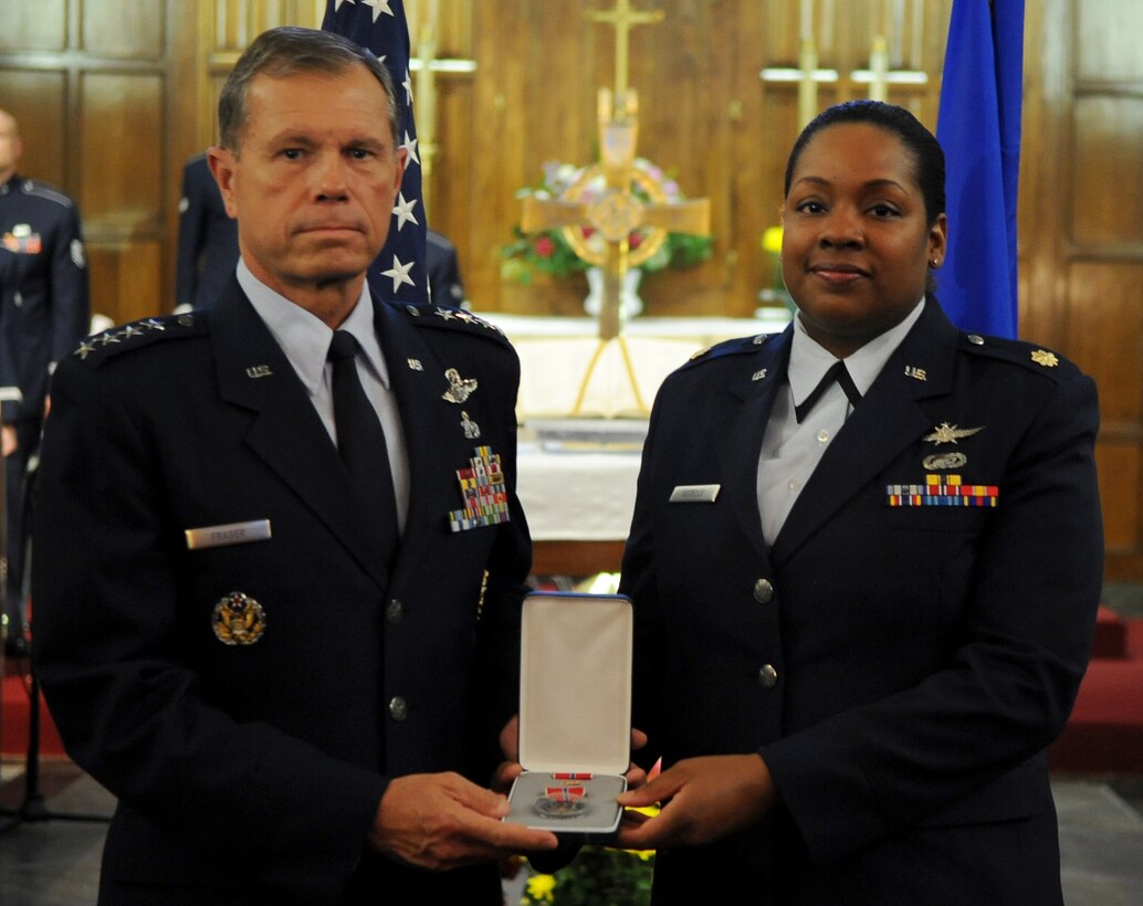 Gen. William Fraser, commander of Air Combat Command, presents Maj. Nikeiba Estelle, 480th Intelligence, Surveillance, and Reconnaissance director of logistics, with the Bronze Star Medal awarded posthumously to her husband, Maj. Raymond Estelle II, during a memorial service at the Langley Chapel at Langley Air Force Base, Va., May 11, 2011. Major Estelle, an Airman assigned to Headquarters Air Combat Command, died April 27 at the Kabul International Airport, Afghanistan, of wounds suffered from gunfire. (U.S. Air Force photo/Senior Airman Antoinette Gibson)(RELEASED)