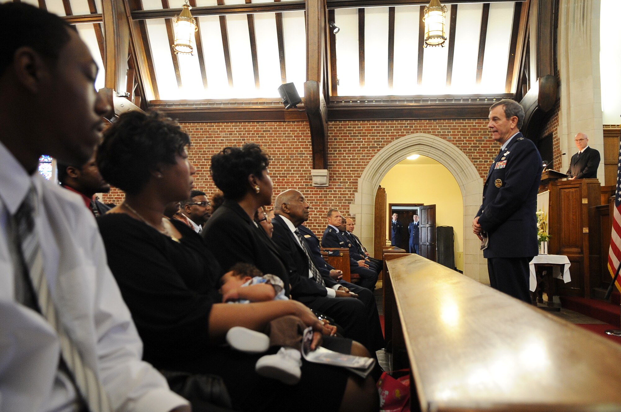 Retired Gen. Stephen Lorenz shares memories of Maj. Raymond Estelle II with his family and friends at a memorial service at the Langley Chapel at Langley Air Force Base, Va., May 11, 2011. Major Estelle, an Airman assigned to Headquarters Air Combat Command, died April 27 at the Kabul International Airport, Afghanistan, of wounds suffered from gunfire. (U.S. Air Force photo/Senior Airman Antoinette Gibson)(RELEASED)