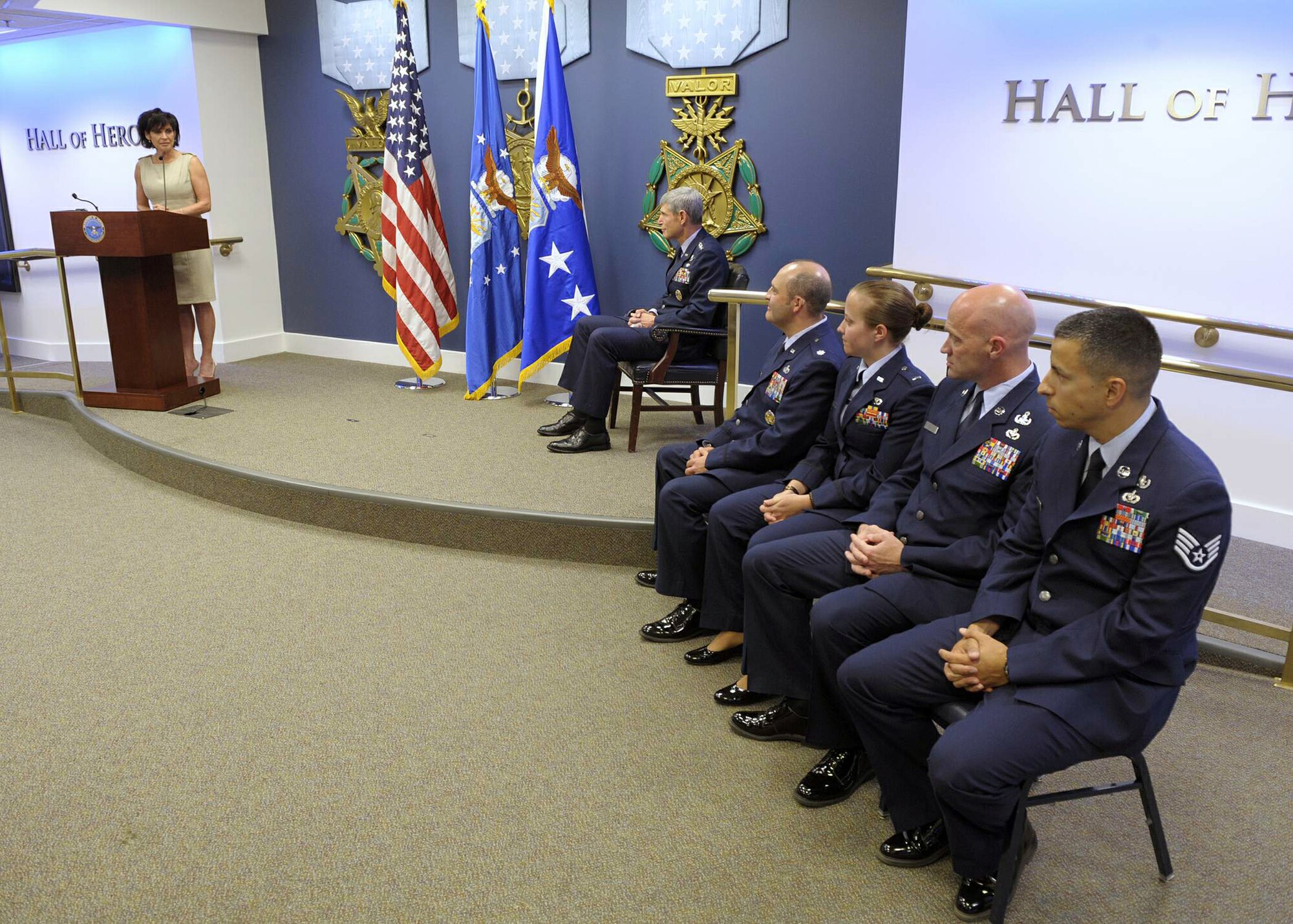 Janine Sijan Rozina provides her remarks during a ceremony May 11, 2011, in the Pentagon's Hall of Heroes to present each of four recipients with a 2010 Lance P. Sijan USAF Leadership Award. This year's recipients are (seated from left) Lt. Col. Tony Millican, 1st Lt. Kathryn Miles, Senior Master Sgt. Brett Rogers and Staff Sgt. Michael Pereira.  Ms. Rozina is the younger sister of the award's namesake. The Sijan Award was created in 1981 to recognize individuals who demonstrate the highest qualities of leadership both in and out of uniform. Air Force Chief of Staff Gen. Norton Schwartz (seated center) hosted the event.  (U.S. Air Force photo/Jim Varhegyi)