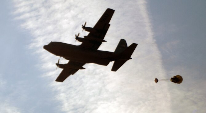 A C-130 Hercules airdrops cargo to ground troops in support of their mission over Afghanistan. C-130’s transport cargo, personnel and airdrop to forward operating bases in the area of responsibility. 

