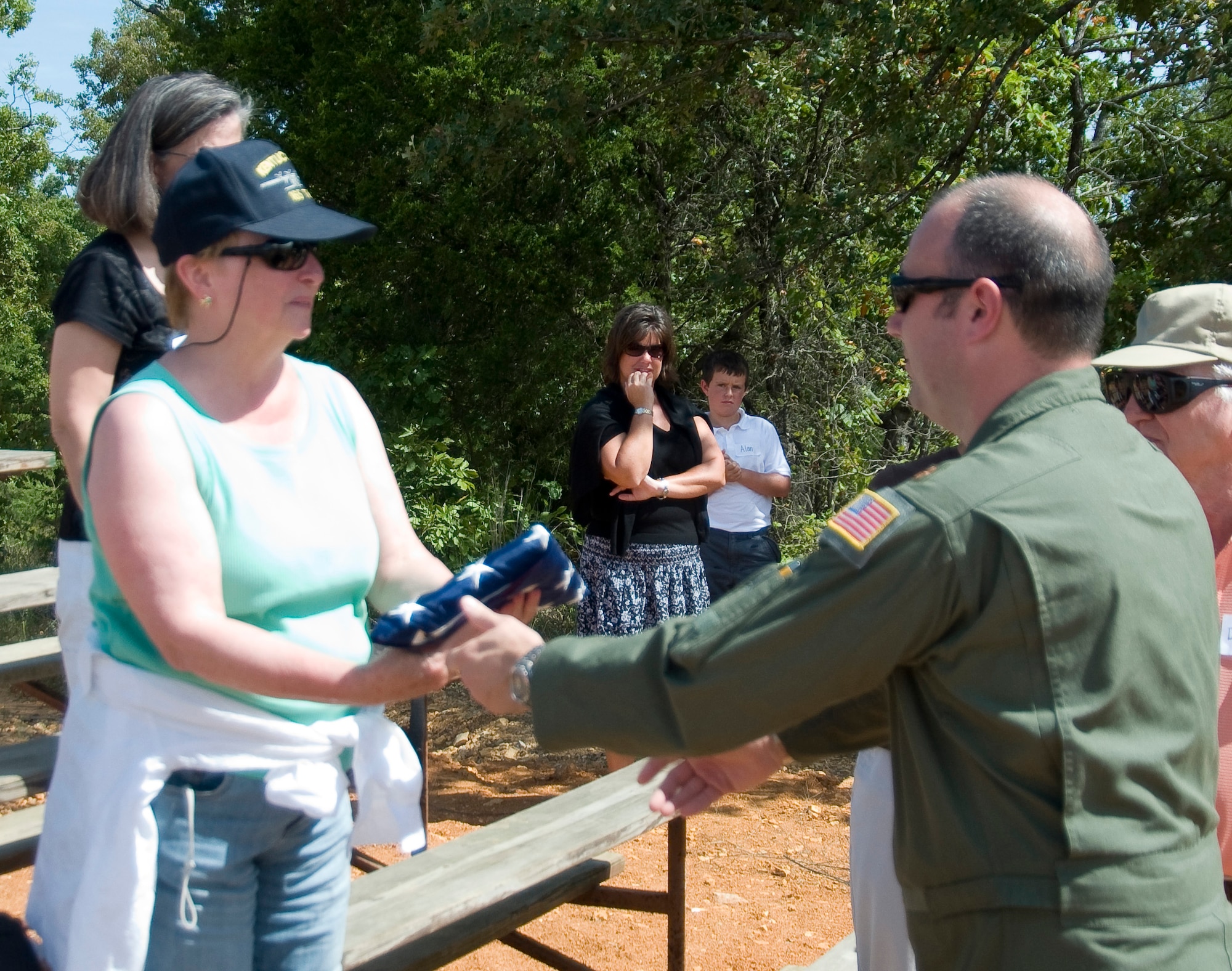 Nancy Kursewicz, sister of Master Sgt. John Medley, receives an American flag at the ceremony commemorating the naming of a drop zone at Fort Knox, Ky., Sept. 14, 2010.  Master Sergeant Medley, 123d loadmaster, who died in a crash during a training flight on Feb. 6, 1992.  (U.S. Air Force photo by Master Sgt. Phil Speck)