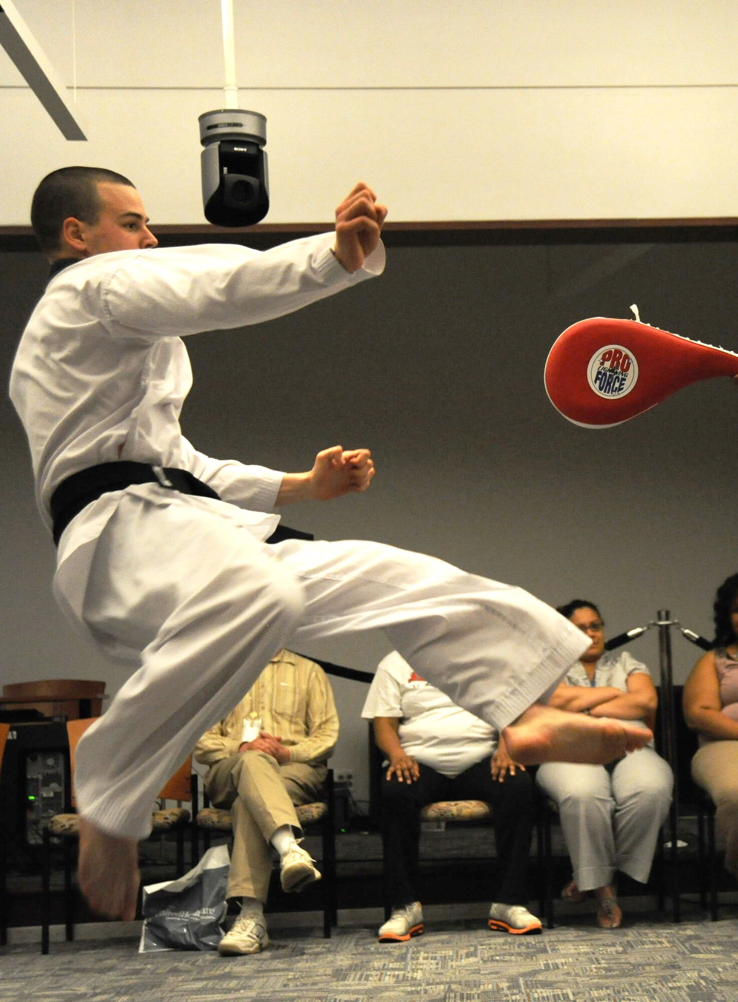 779th Medical Support Squadron logistics technician Airman 1st Class Shane Borodycia demonstrates a dragon kick during a health and wellness demonstration May 11 at the U.S. Department of Transportation's Headquarters, Washington, D.C. Airman Borodycia, a black belt, attends Tae Kwon Do classes led by Air Force District of Washington's Deputy Director of Lessons Learned Lt. Col. Henry Lane, at Joint Base Anacostia-Bolling, Washington D.C. and Joint Base Andrews, Md. (USAF Photo by Benjamin Newell)