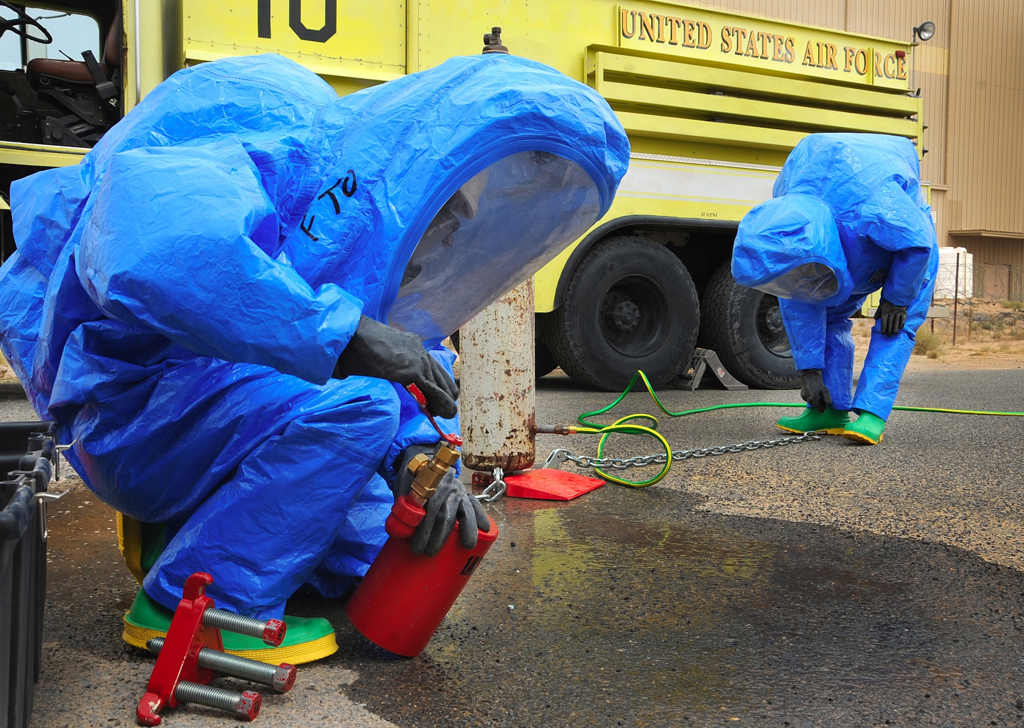 A firefighter with the 386th Expeditionary Civil Engineer Squadron at an air base in Southwest Asia prepares a cap to seal a leaking valve during a hazardous material technical training exercise. It is a Department of Defense requirement that all Air Force firefighters be certified to the hazmat technical level. (U.S. Air Force photo/Senior Airman Cynthia Spalding)
