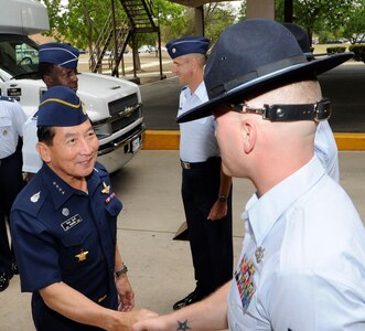 Air Chief Marshal Itthaporn Subhawong, Commander-in-Chief, Royal Thai air force is greeted by Military Training Instructors at Lackland Air Force Base, San Antonio, Texas on May 11, during his visit to Lackland's Basic Military Training complex. (U.S Air Force Photo By Don Lindsey)