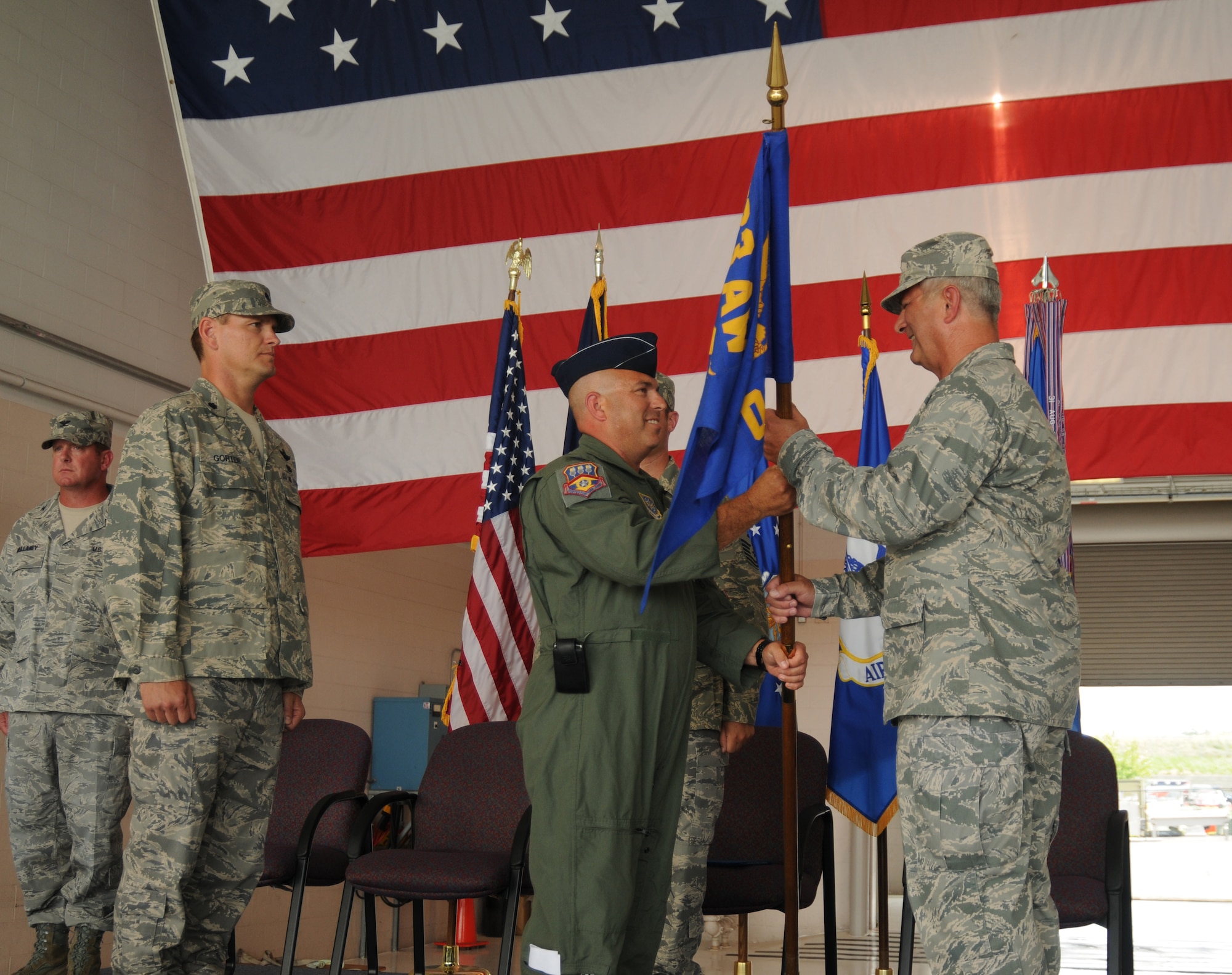 Col. Kenneth J. Dale, center, receives the Kentucky Air National Guard 123d Maintenance Group guidon from Col. Bill Ketterer, interim 123d Airlift Wing Commander, during a dual change of command ceremony here July 18 . The passing of the guidon officially marks Colonel Dale’s assumption of commander of the group. Lt. Col. Barry D. Gorter, far left, assumed command of the 123d Operations Group during the ceremony.   (U.S. Air Force photo by Technical Sgt. Dennis Flora)