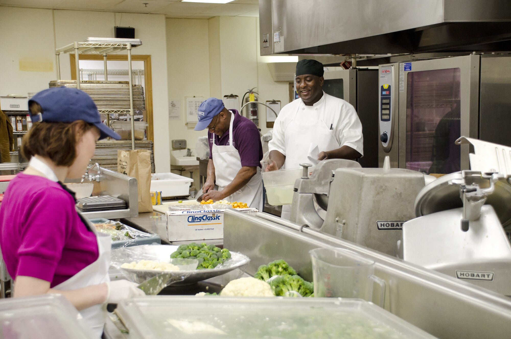 From left to right: caterer Brenda Marshall, Scott Club manager Graelin Garlington, and cook supervisor Clint Collier prepare food May 6, 2011 in the kitchen at the Scott Club at Scott Air Force Base, Ill.  The club added two certified chefs to its staff recently, including Mr. Collier. (U.S. Air Force photo/Steve Berry) 

