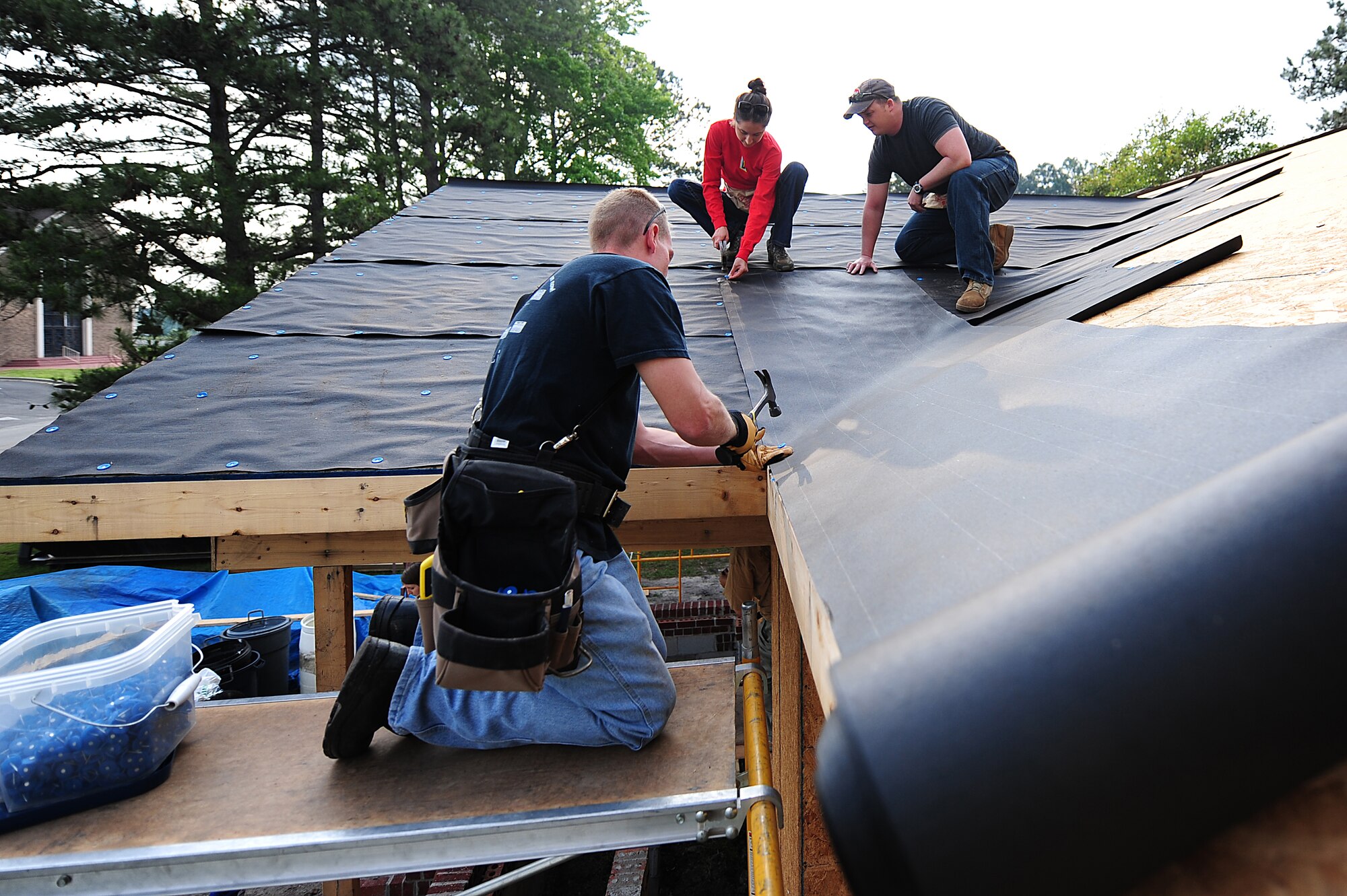 SEYMOUR JOHNSON AIR FORCE BASE, N.C. -- Airmen and dependents add a roof to a house for Habitat for Humanity here, May 10, 2011. Airmen make up a large amount of the work force within the Goldsboro Habitat of Humanity volunteer group. (U.S. Air Force photo/Senior Airman Rae Perry)(RELEASED) 